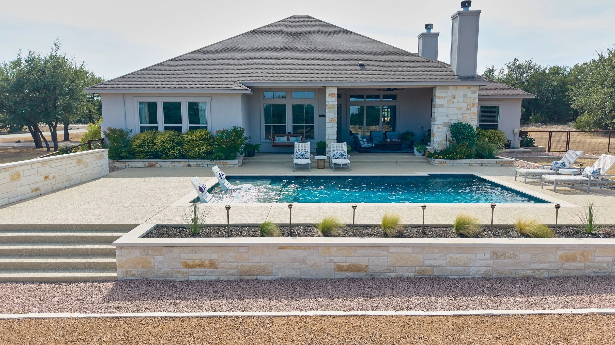 Custom pool overview with Ivory travertine coping — Spicewood