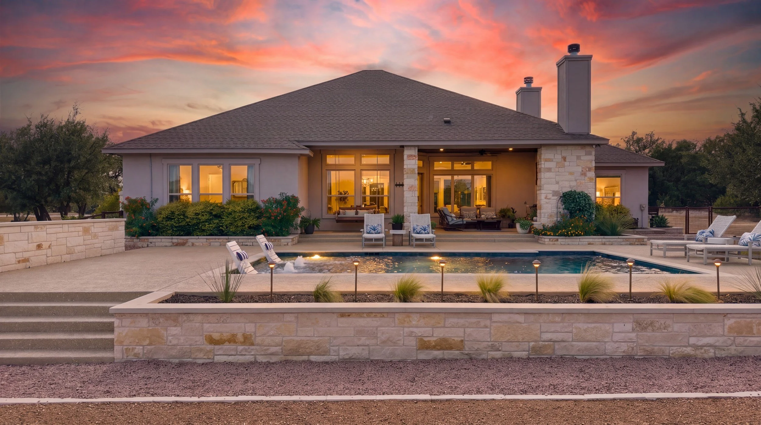 Poolside patio at sunset — Spicewood custom pool