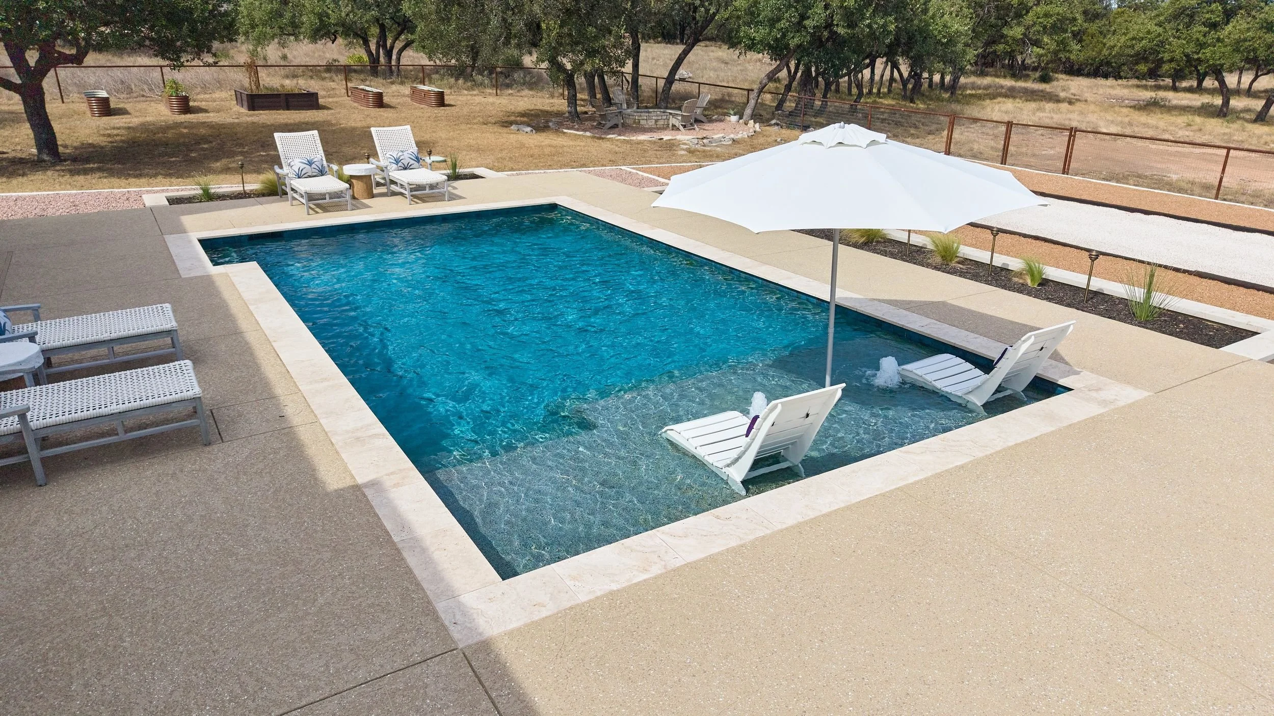 Pool deck with umbrella and Coral Gorgonian Teal tile — Spicewood