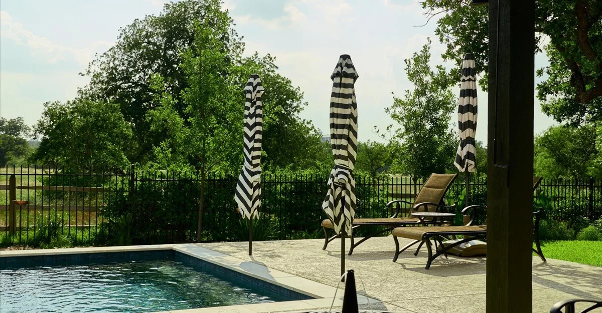 Poolside loungers on Terranova travertine deck — Horseshoe Bay
