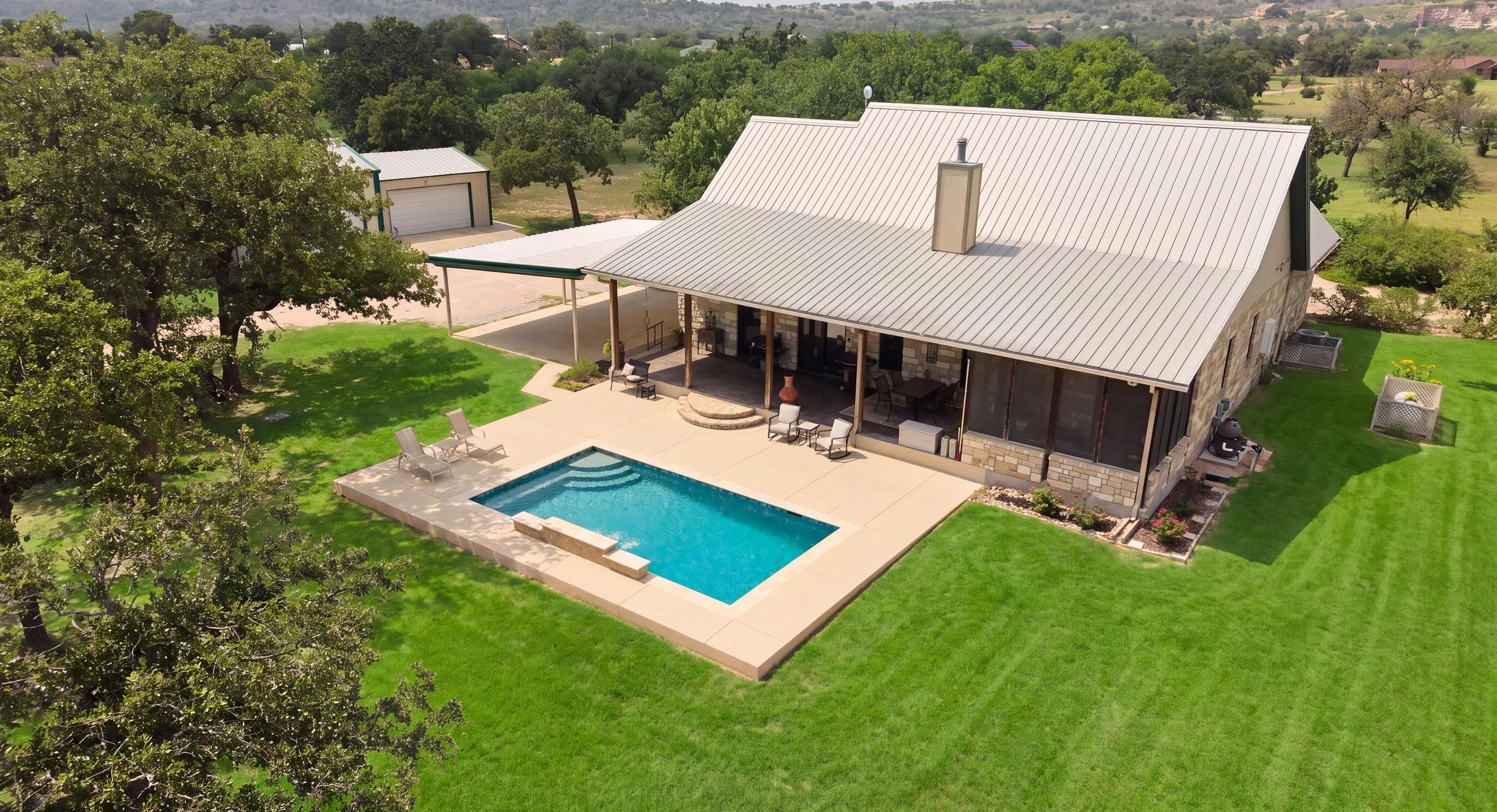 Aerial view of property and custom pool — Kingsland Texas