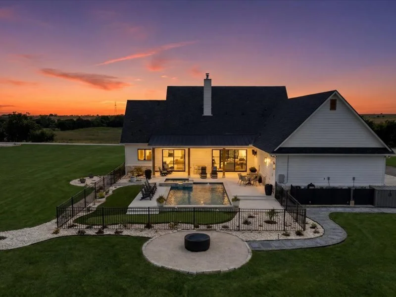 Twilight aerial view — custom pool with spa lighting, Salado Texas