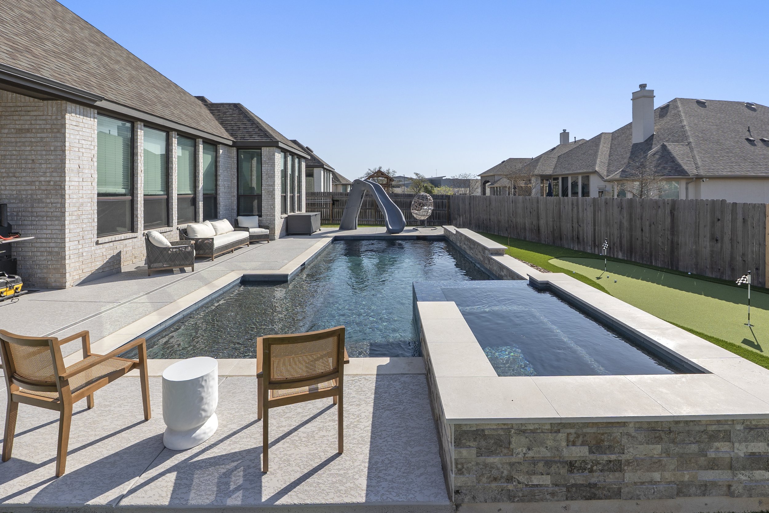 Rectangular gunite pool with modern design and integrated spa