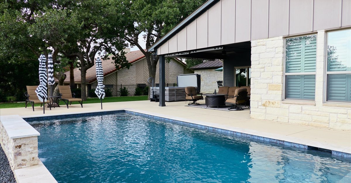Pool with covered patio and outdoor living area — Horseshoe Bay TX