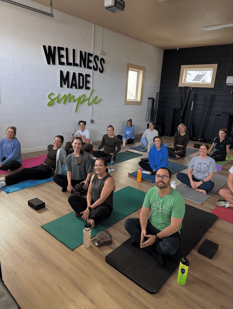 A yoga group seated on their mats at SoDel Well
