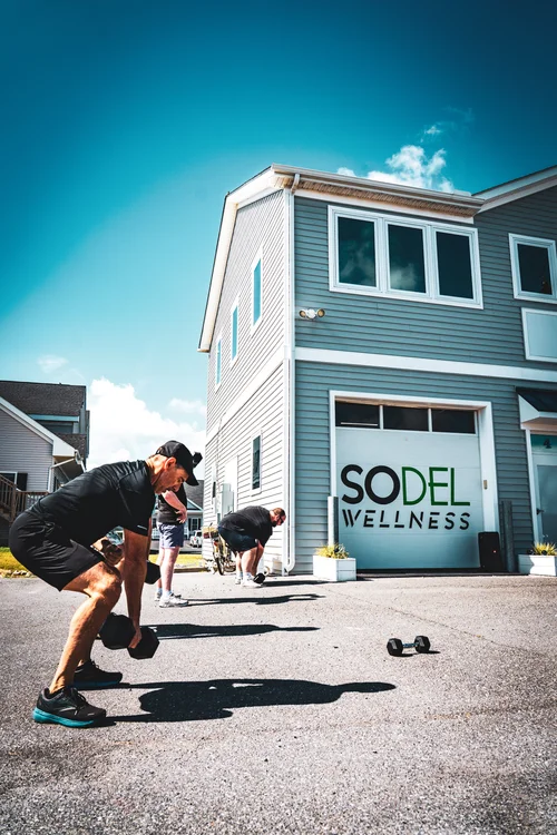 SoDel Wellness sign above the entrance on the gray building