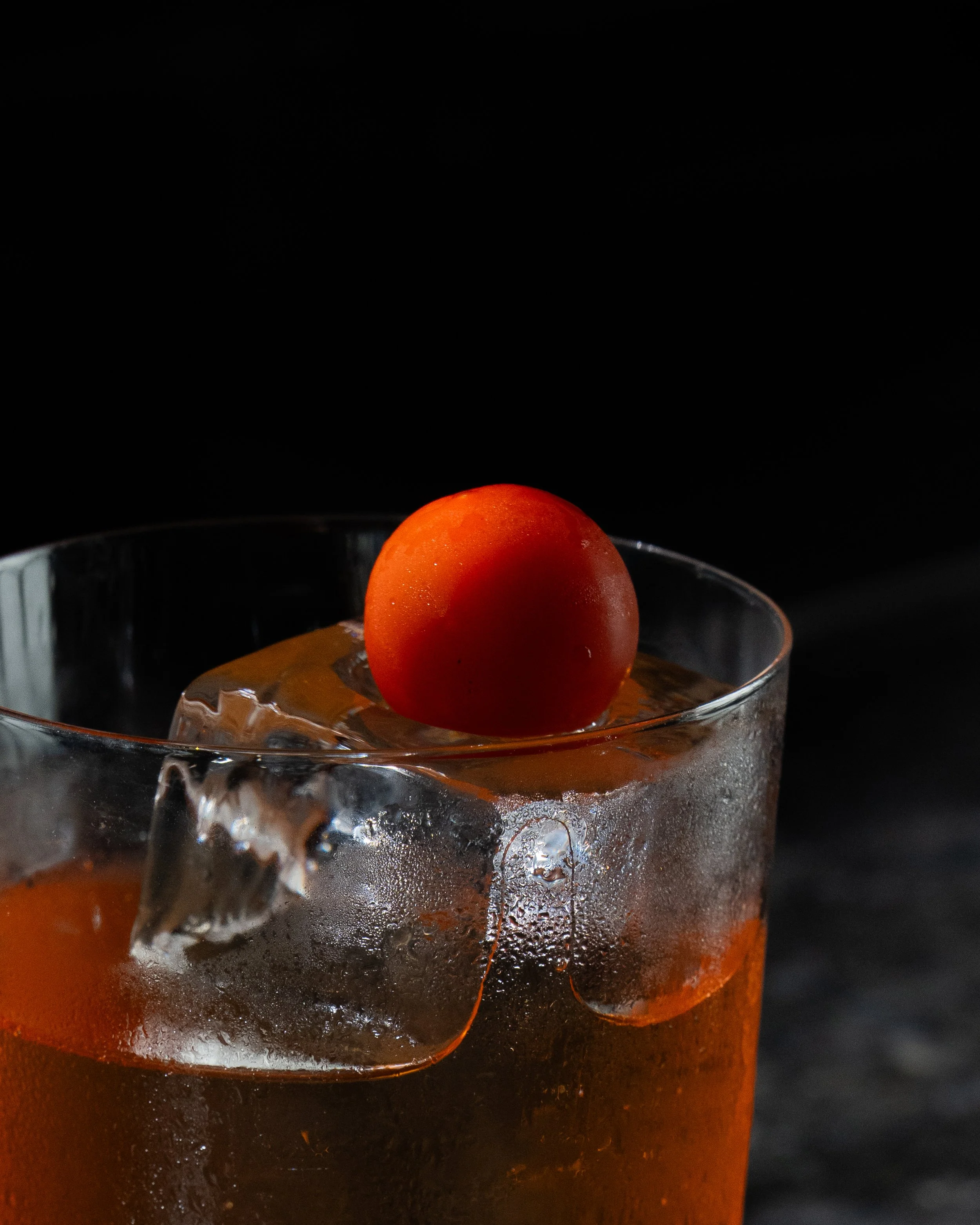 Dark cocktail with orange peel