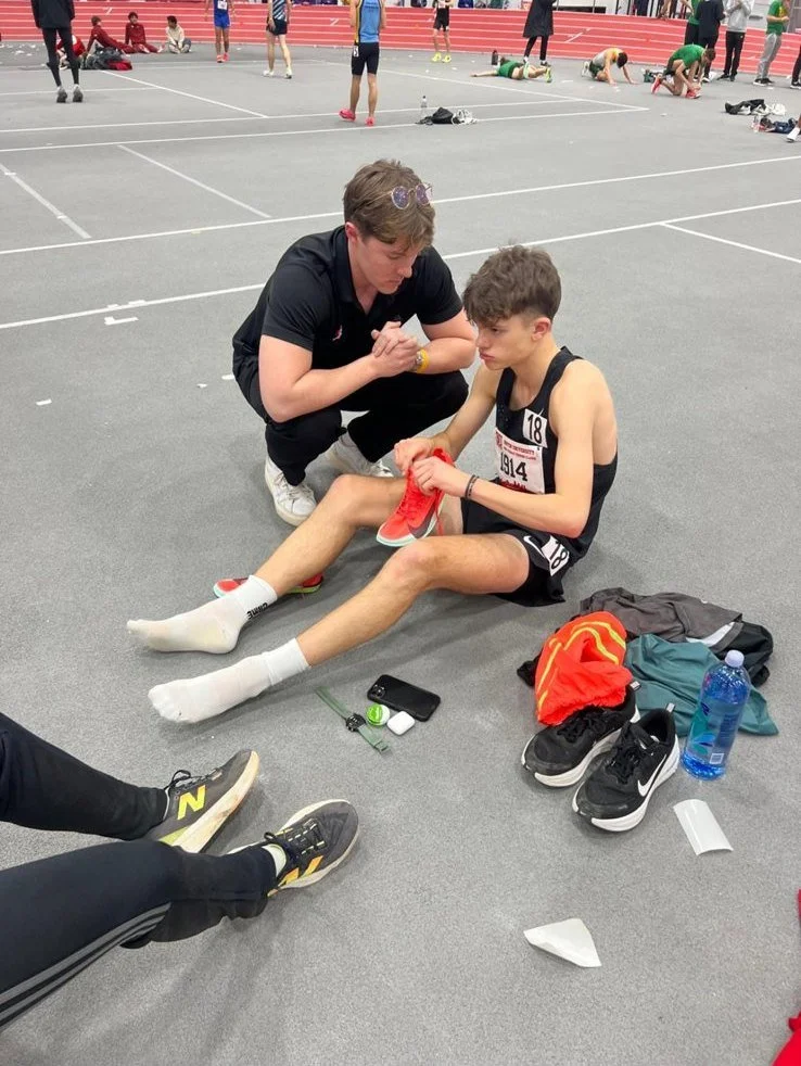 An OSS coach helping an athlete prepare before a race