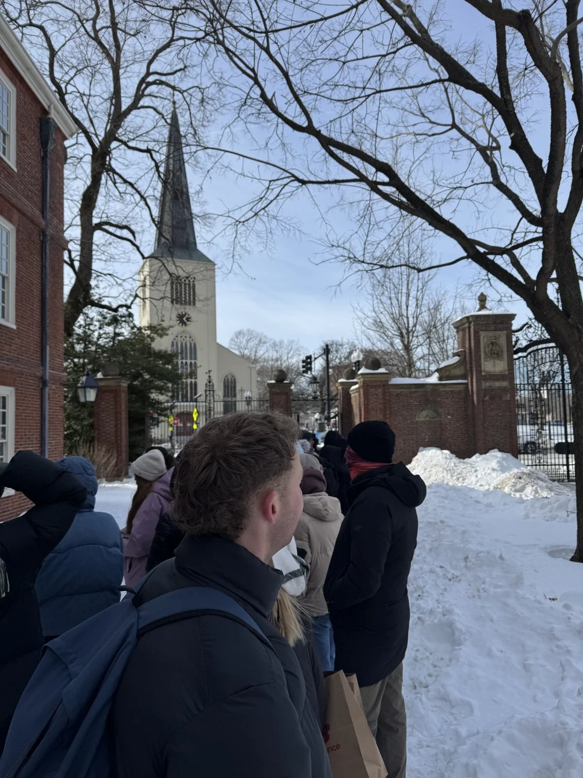 Athletes on a campus tour of Harvard in the snow