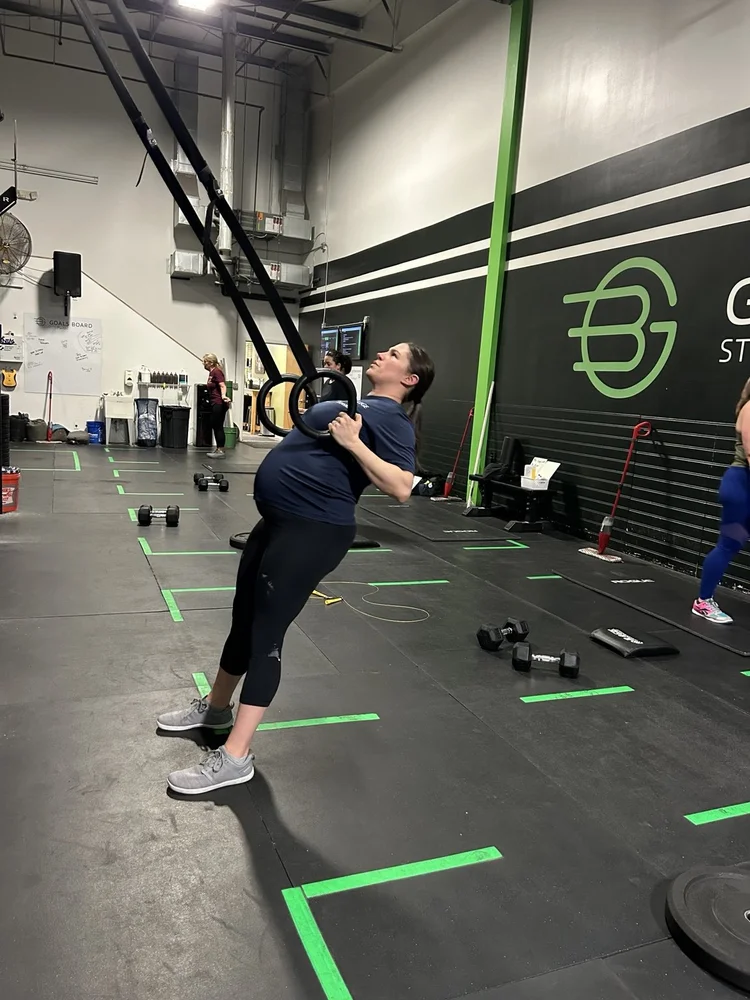 A GBSC member performing ring rows in the Newington gym