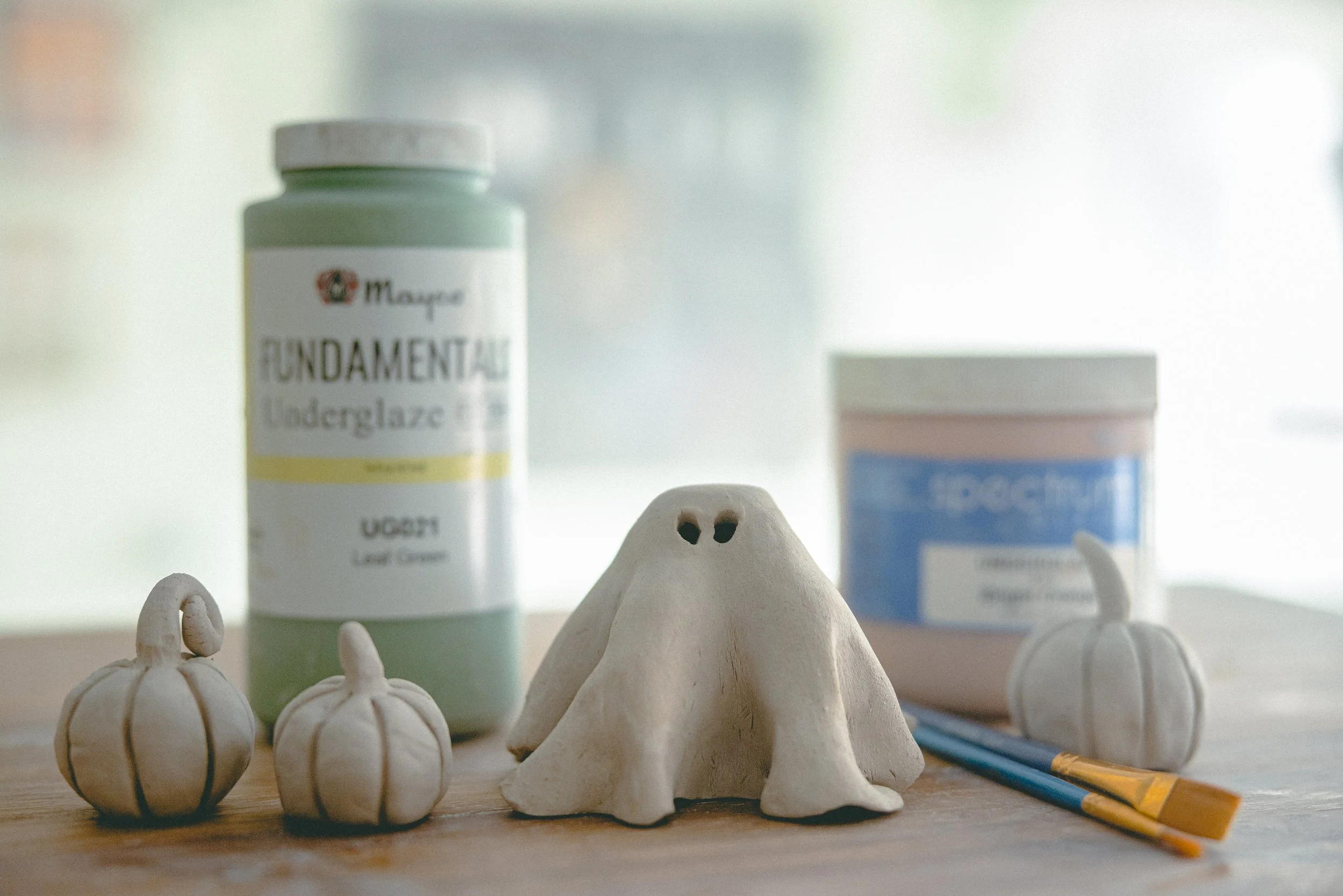 Handbuilt ceramic ghost and mini pumpkins at the Halloween paint and sip at Floridian Ceramics in Tampa