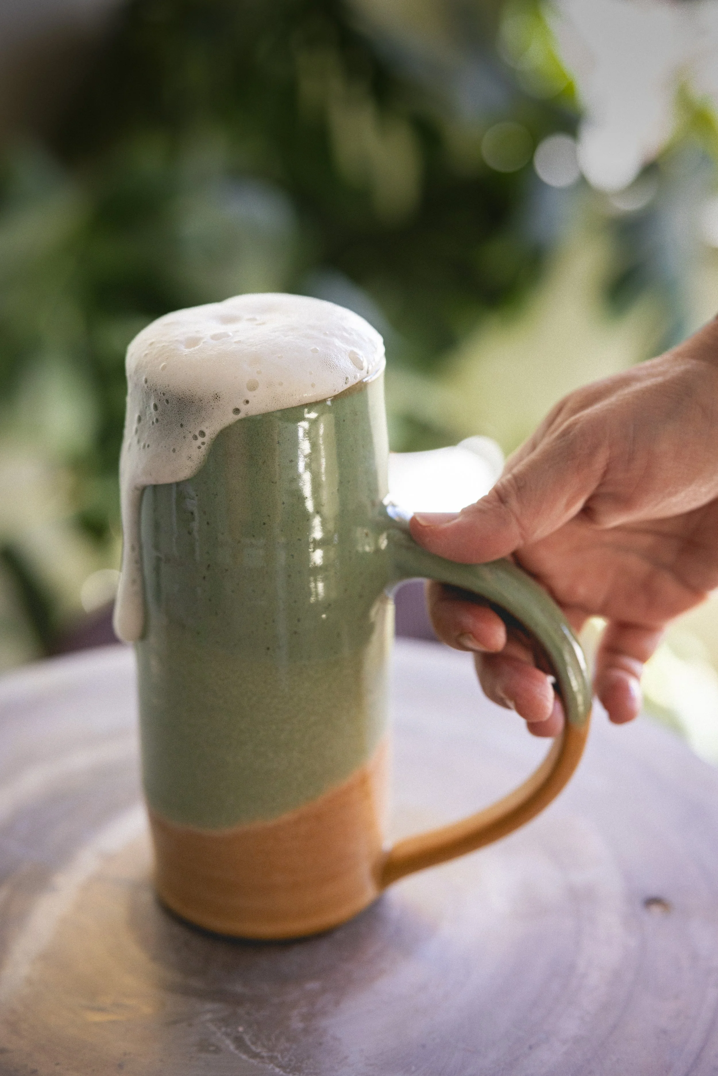Handmade ceramic stein filled with beer for Oktoberfest at Floridian Ceramics in Tampa