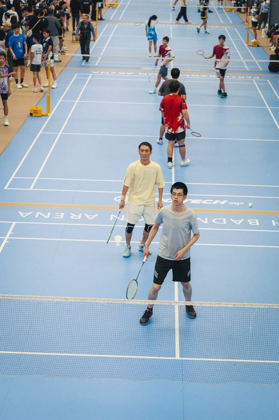 A tournament in play across the arena's courts