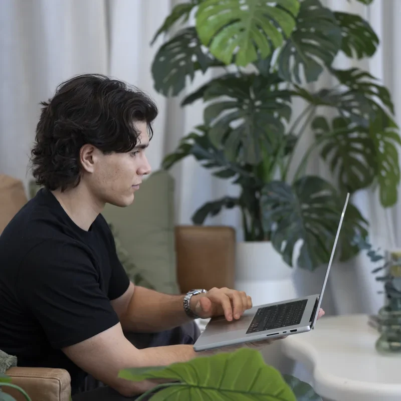 An IRO Creative team member working at a laptop in the studio