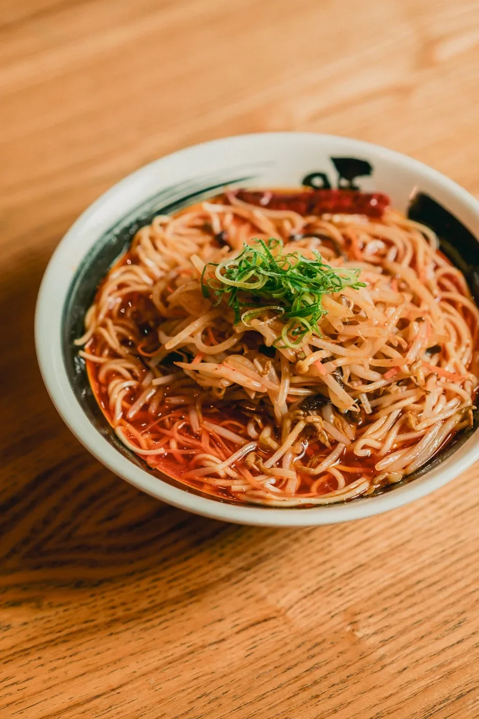 Spicy noodle dish finished with spring onion