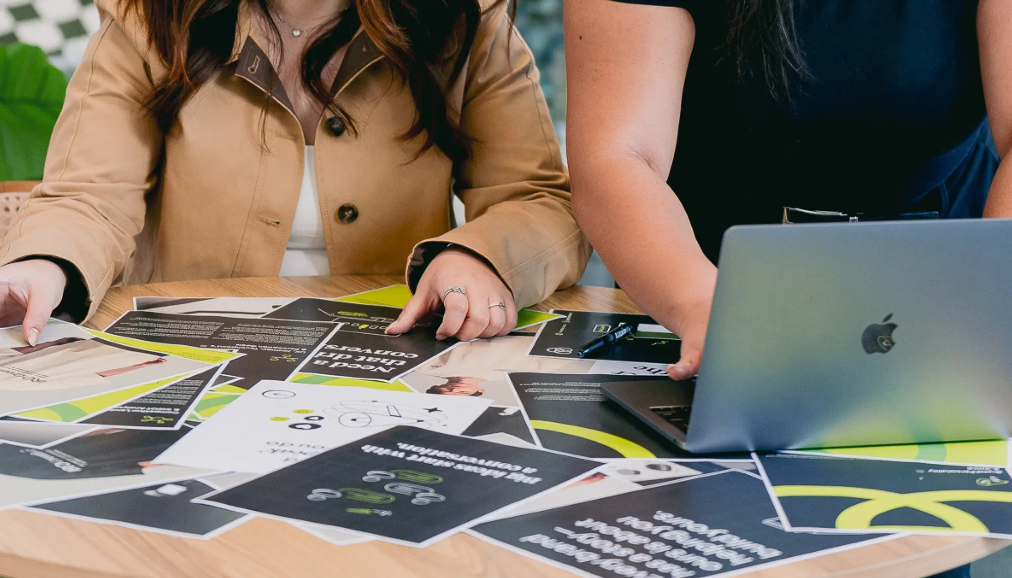 Two IRO Creative team members collaborating over design work