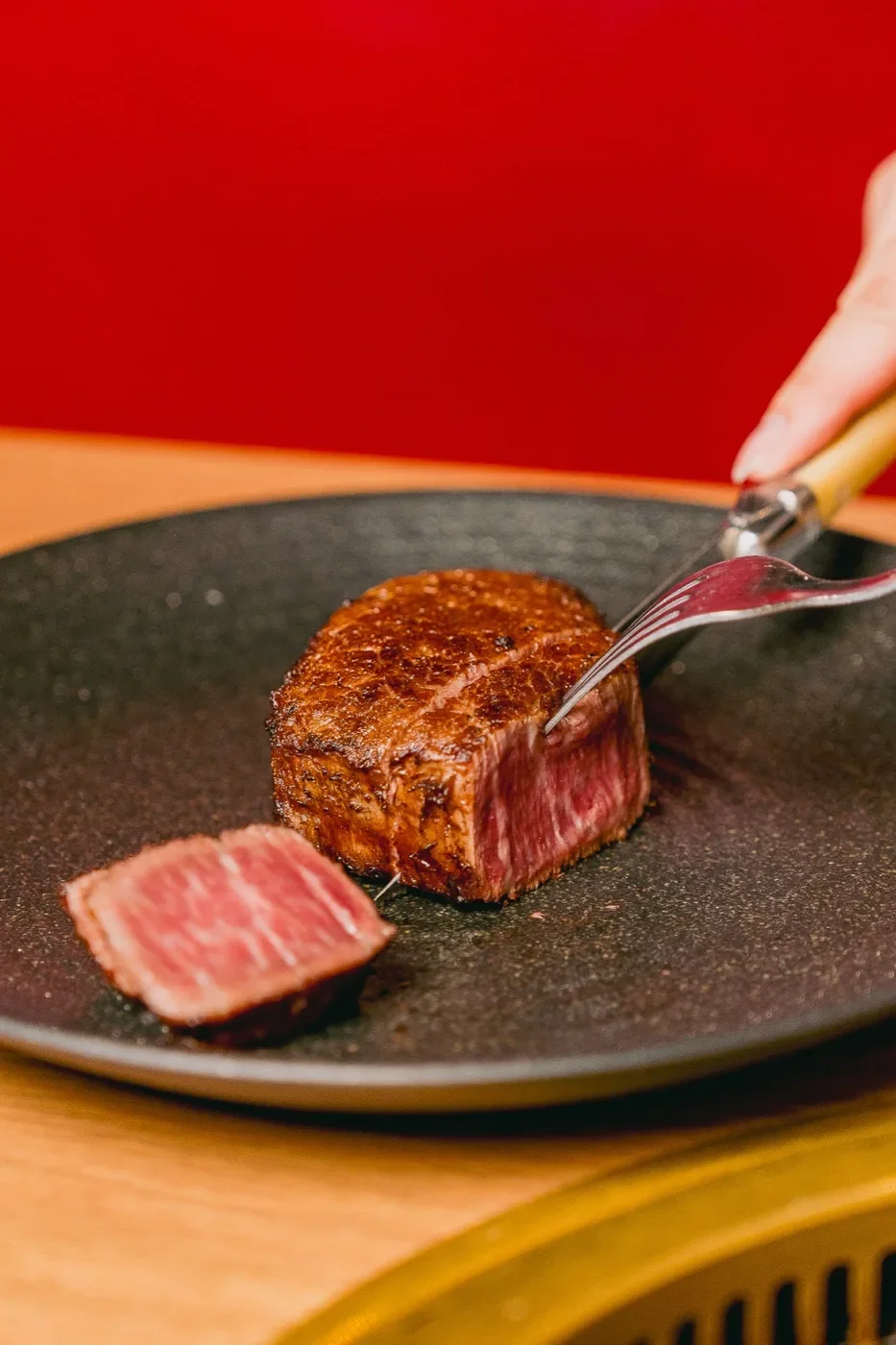 Seared wagyu steak sliced to show the centre