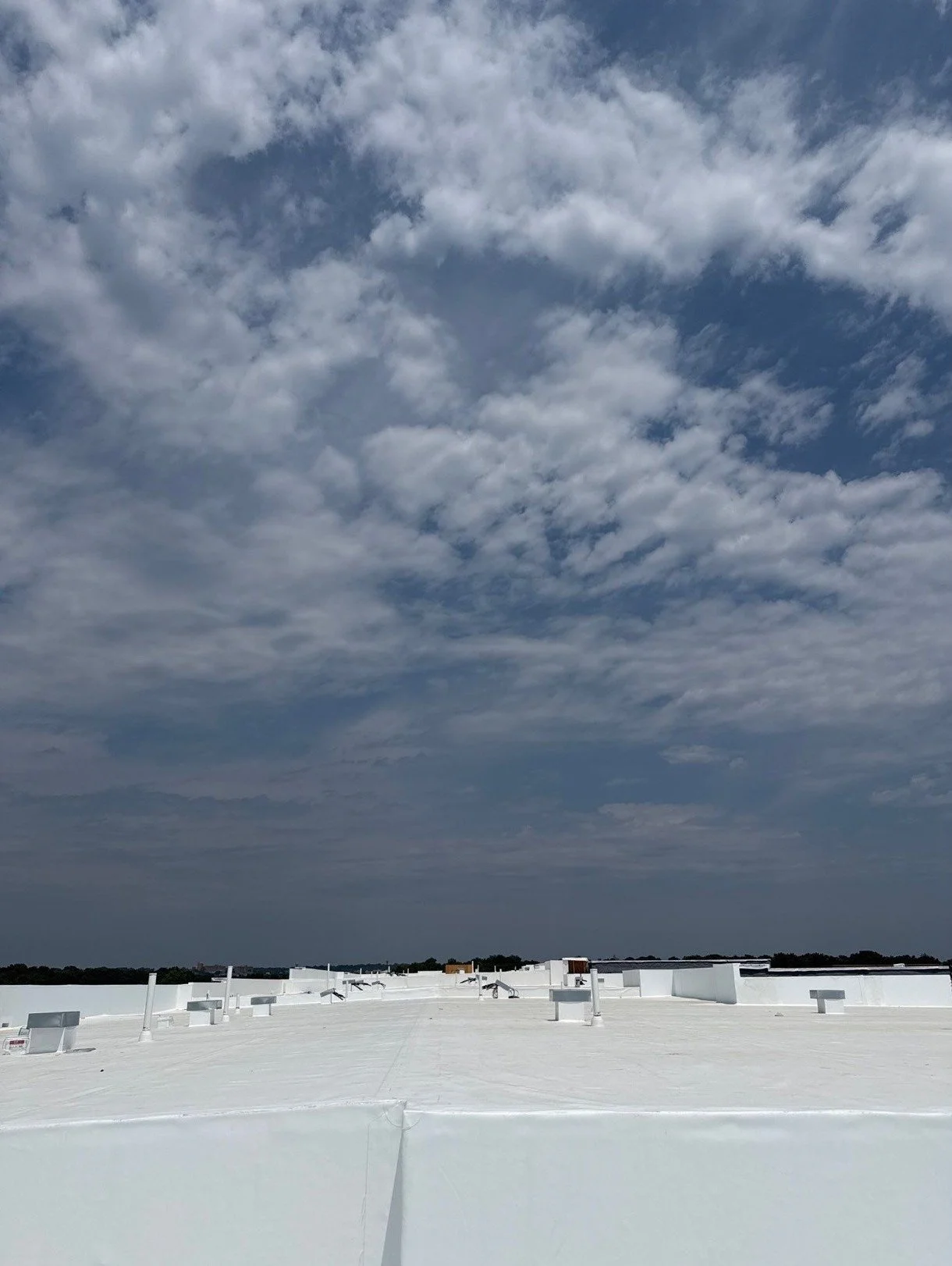 White TPO flat roof membrane on a Kansas City commercial building