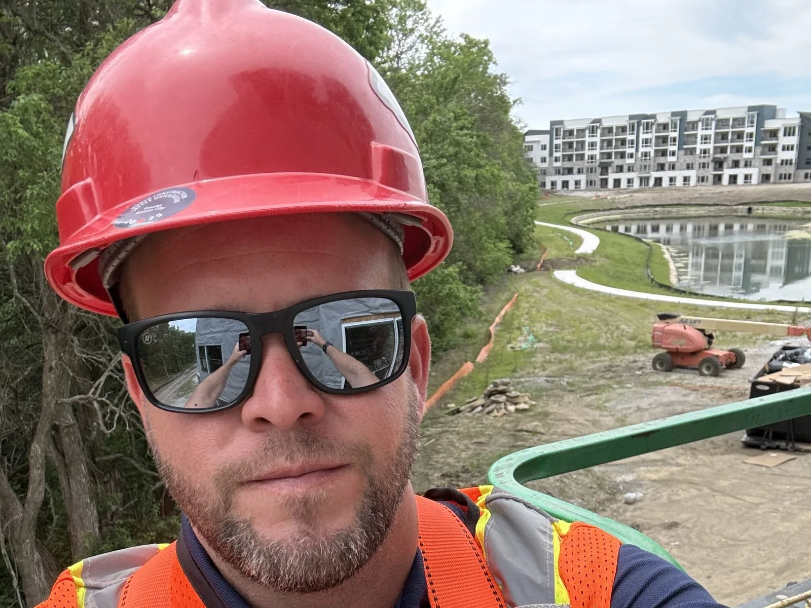 Green Home & Building on a lift at a Kansas City multifamily construction site
