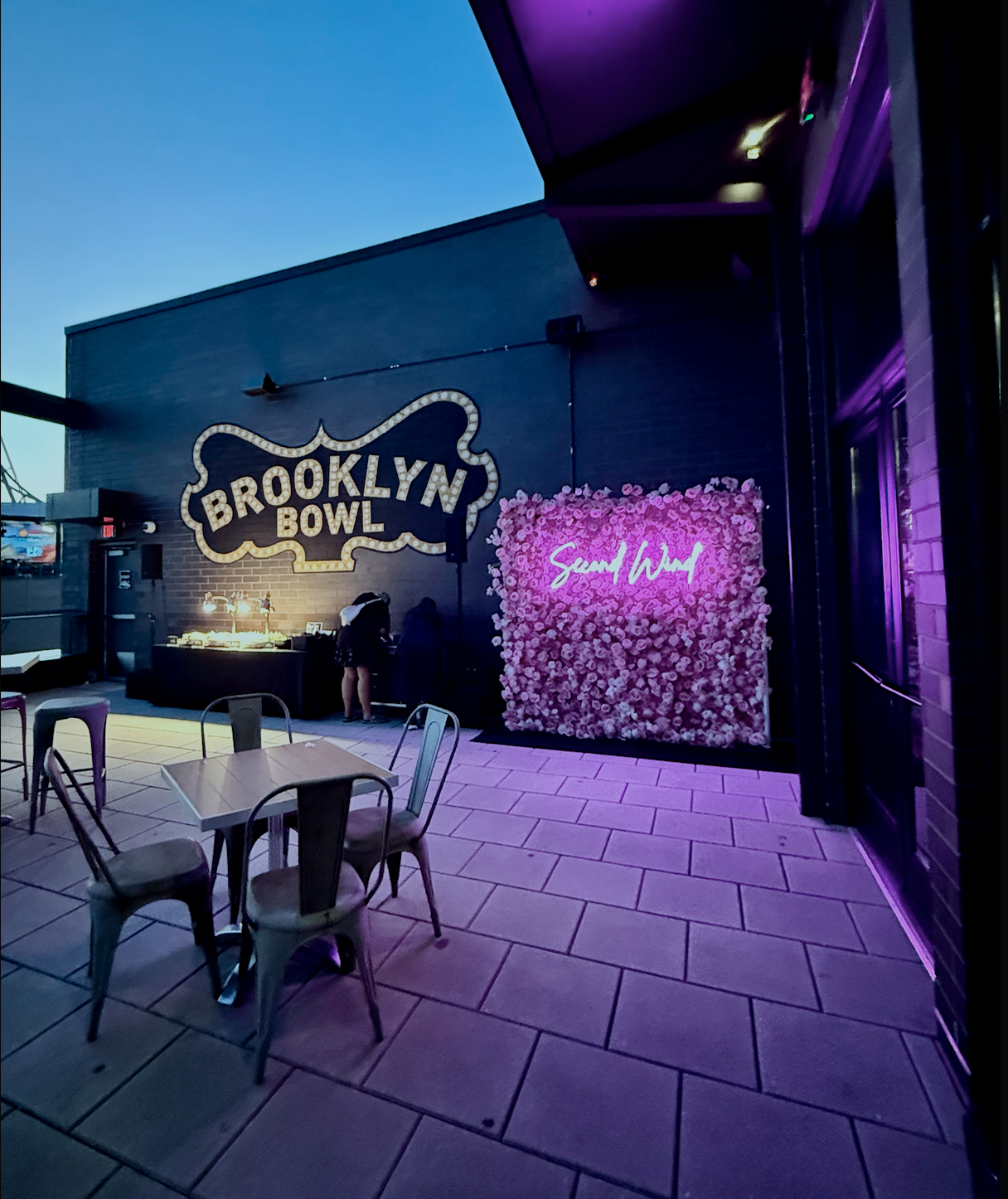 Custom step and repeat alternatives showing a pink flower wall backdrop with neon sign for a Broken Bow Records media activation