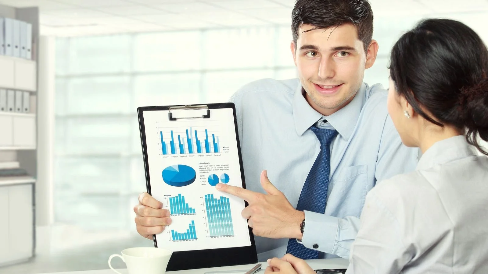 Two business partners reviewing marketing results together at a table
