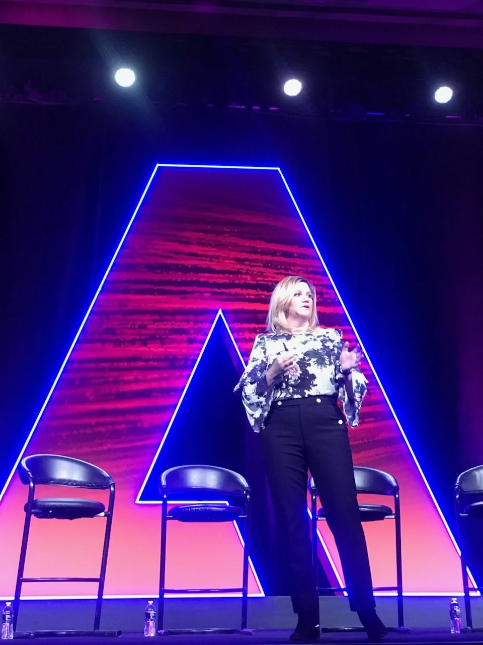 Laurie speaking on stage at an Adobe event