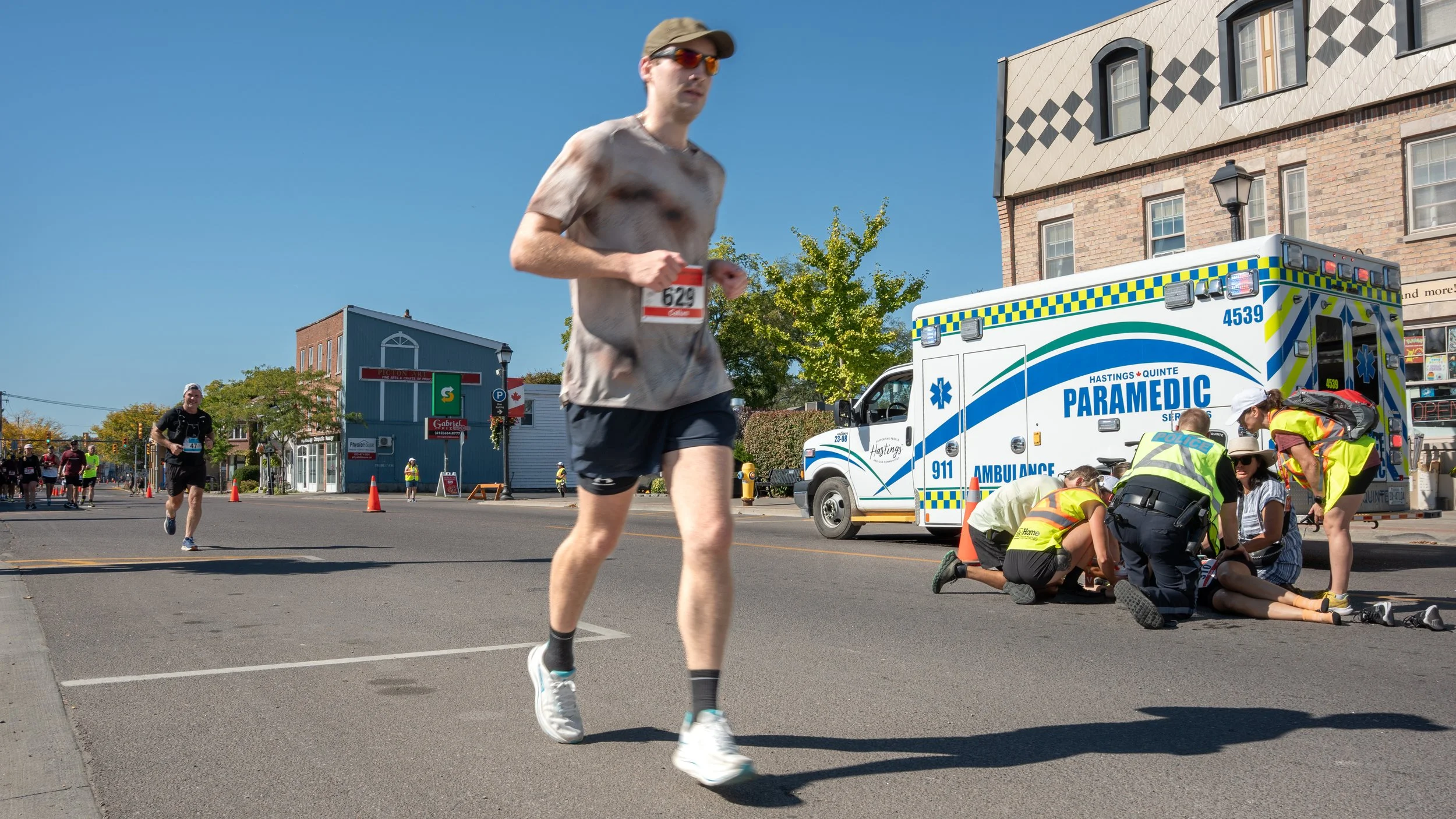 Runners and spectators line a County Marathon course in Prince Edward County, Ontario, as the community turns out in record numbers.