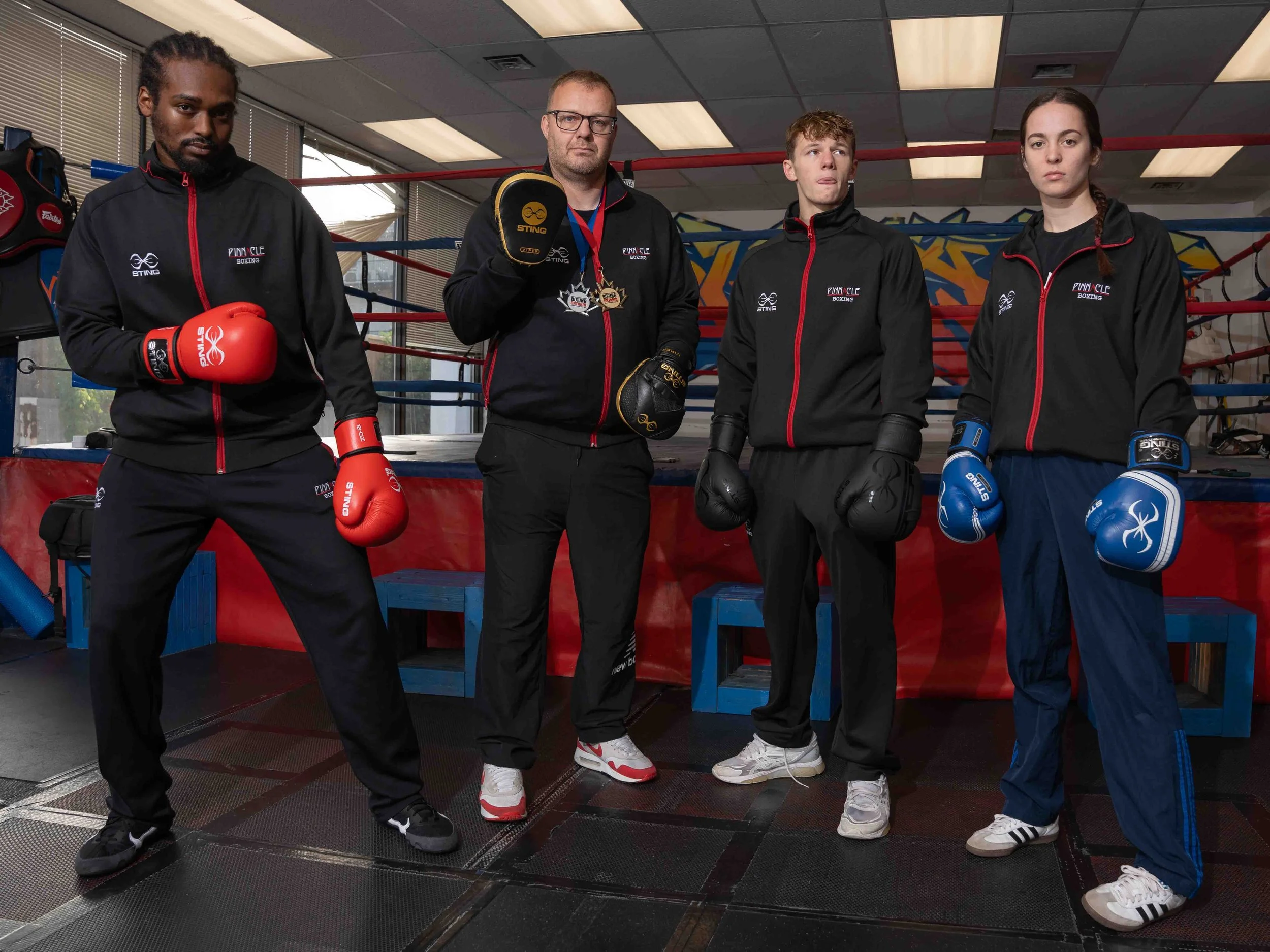 Team Pinnacle Boxing members D’Andrej Felix, Coach Blair Crawford, Avery Crawford, and Makayla Johnson pose together after winning medals at the Ontario provincial boxing championships in Belleville.