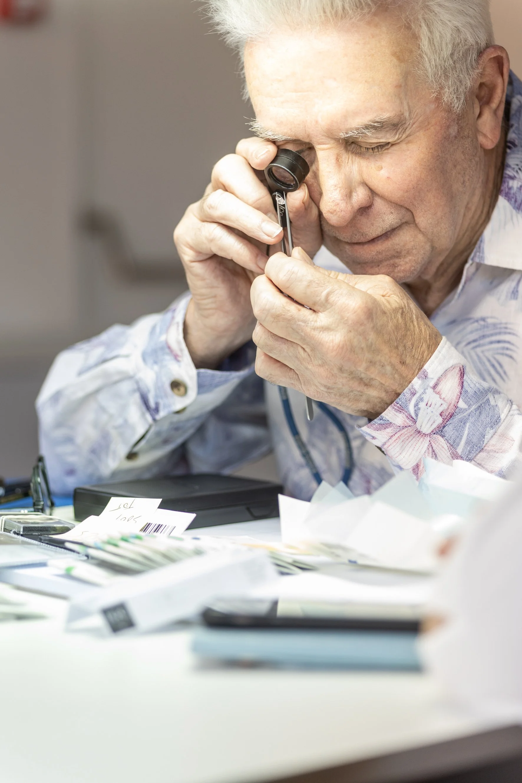 Diamond dealer inspecting a diamond through a loupe