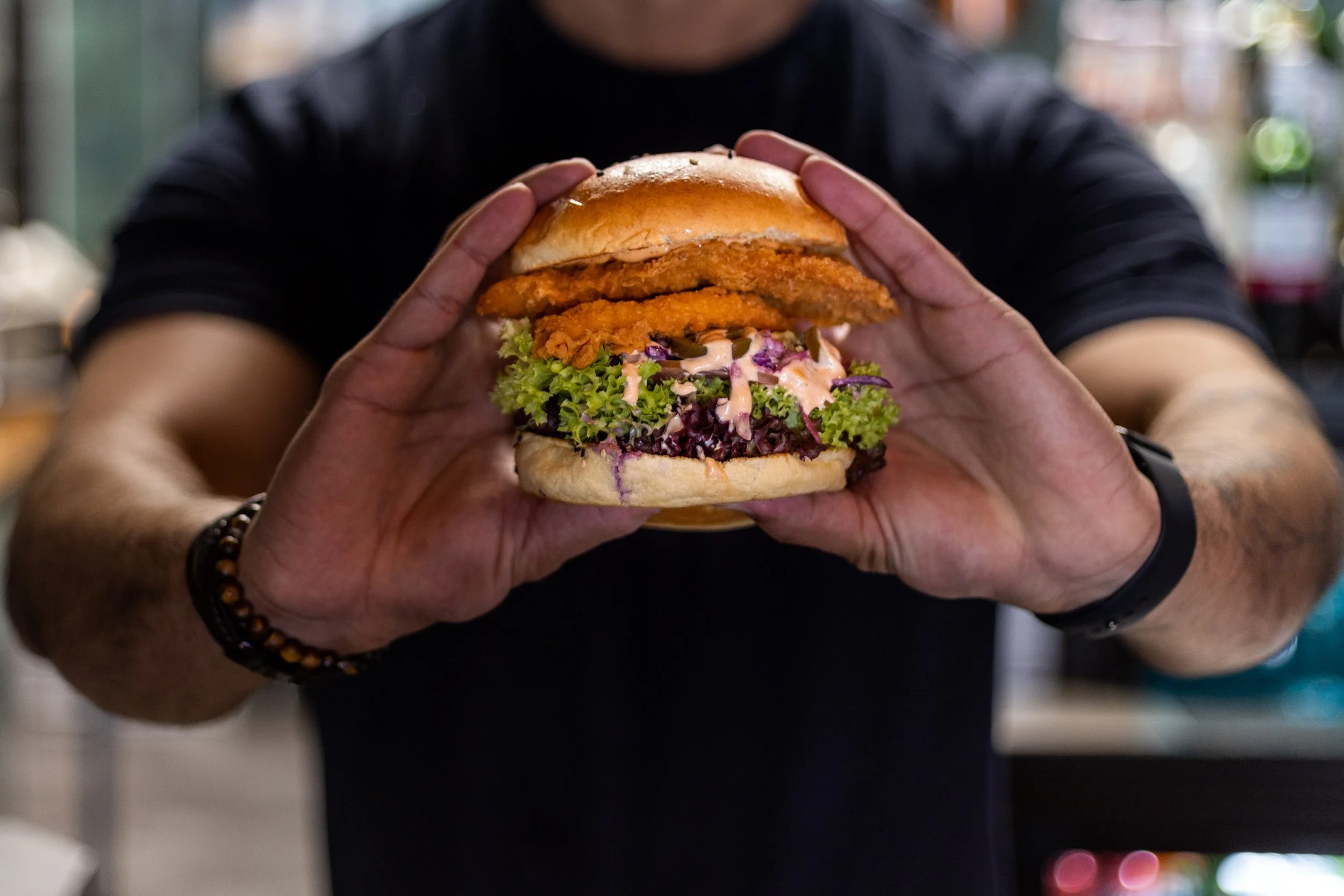 Food photography of a burger held in hand