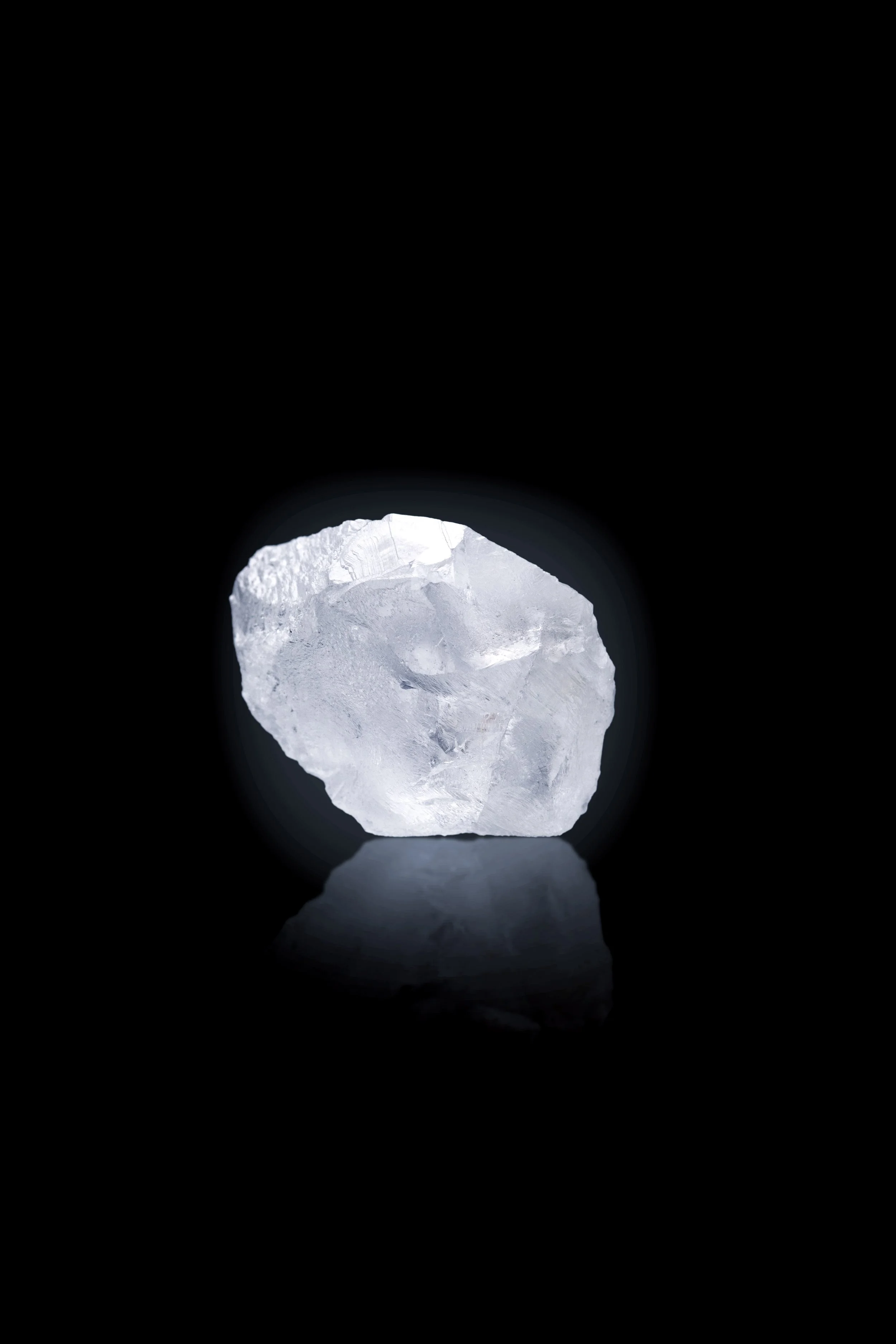 Product photography of an uncut raw diamond on black background