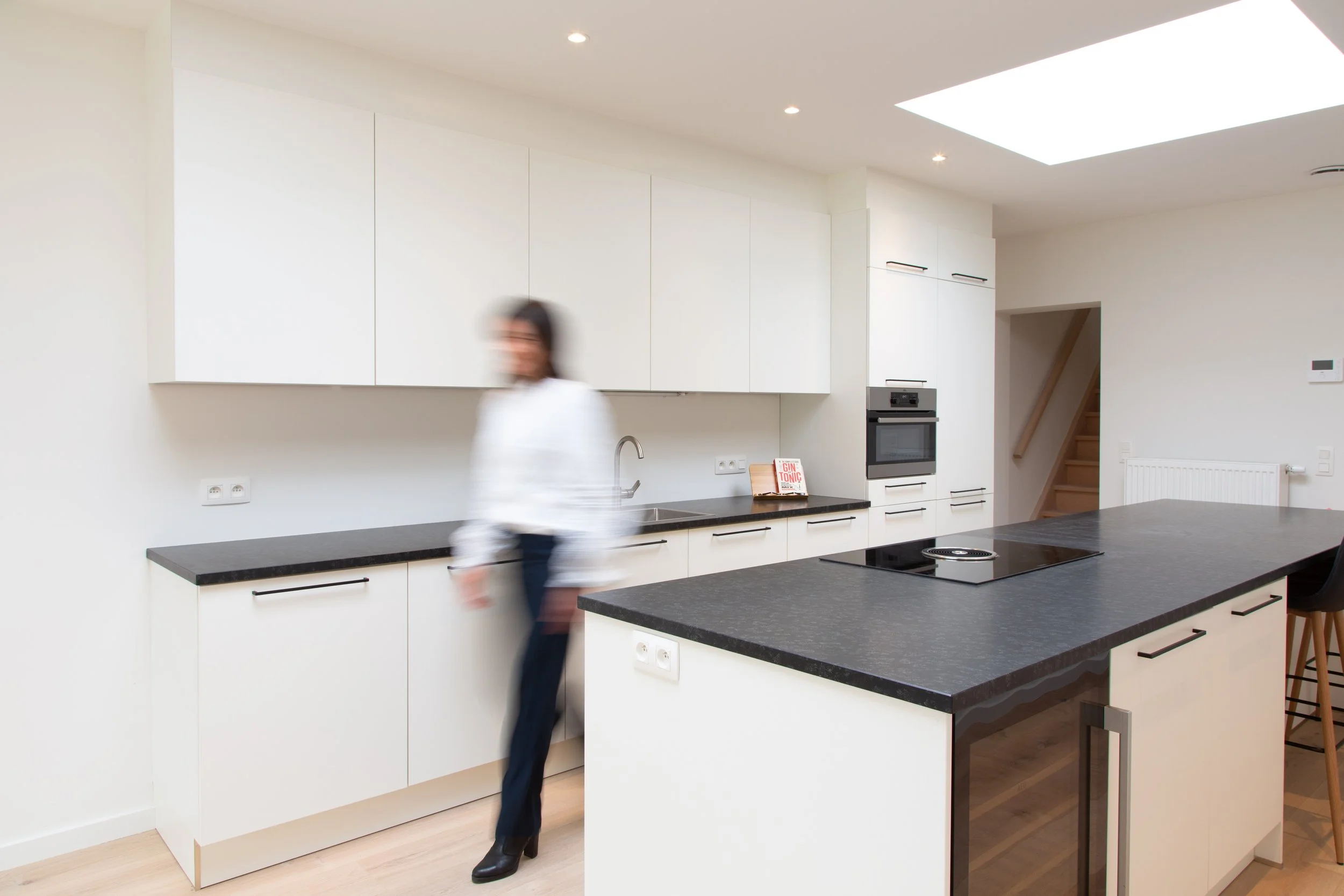 Kitchen with unsharp person walking past