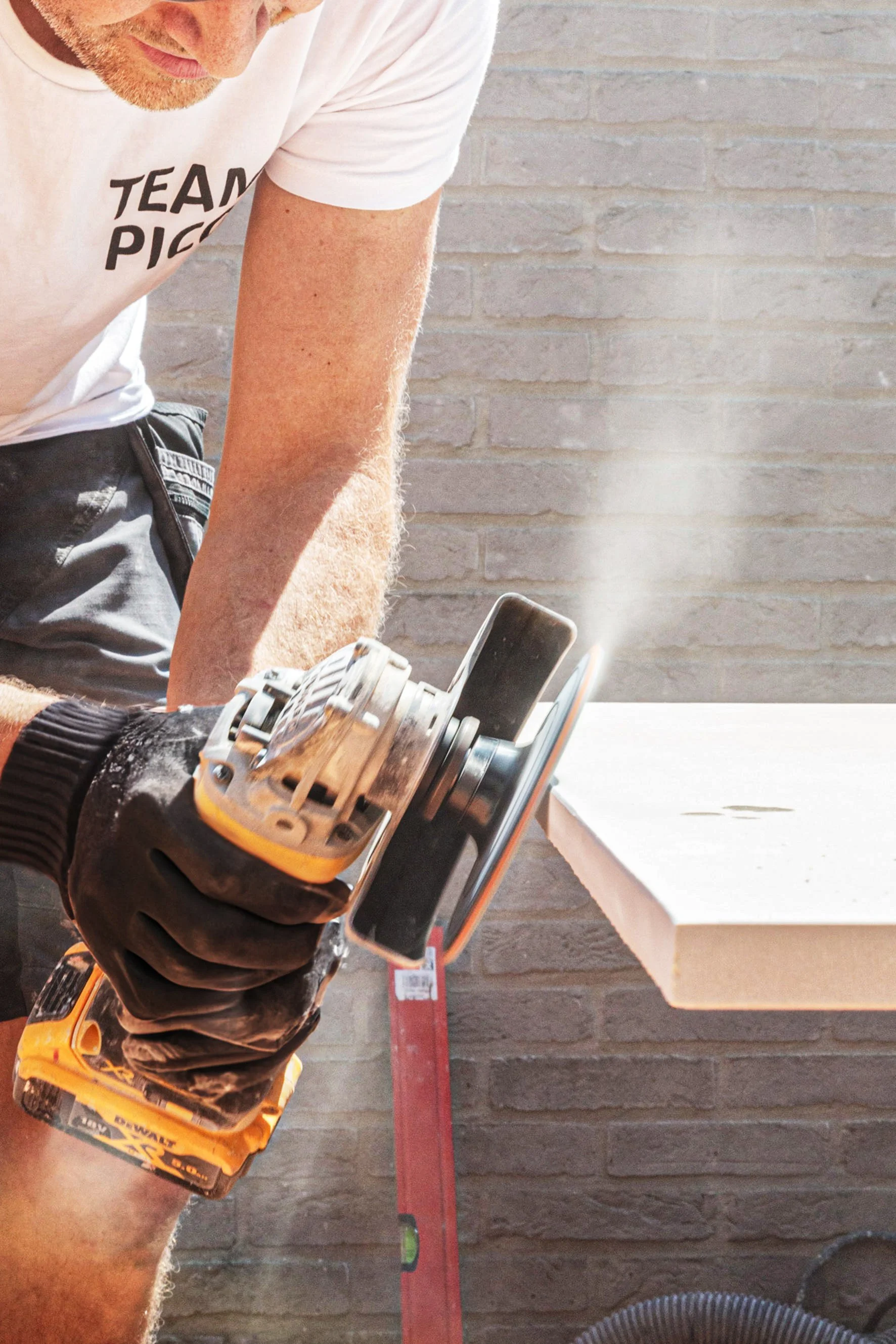 Construction worker cutting a tile