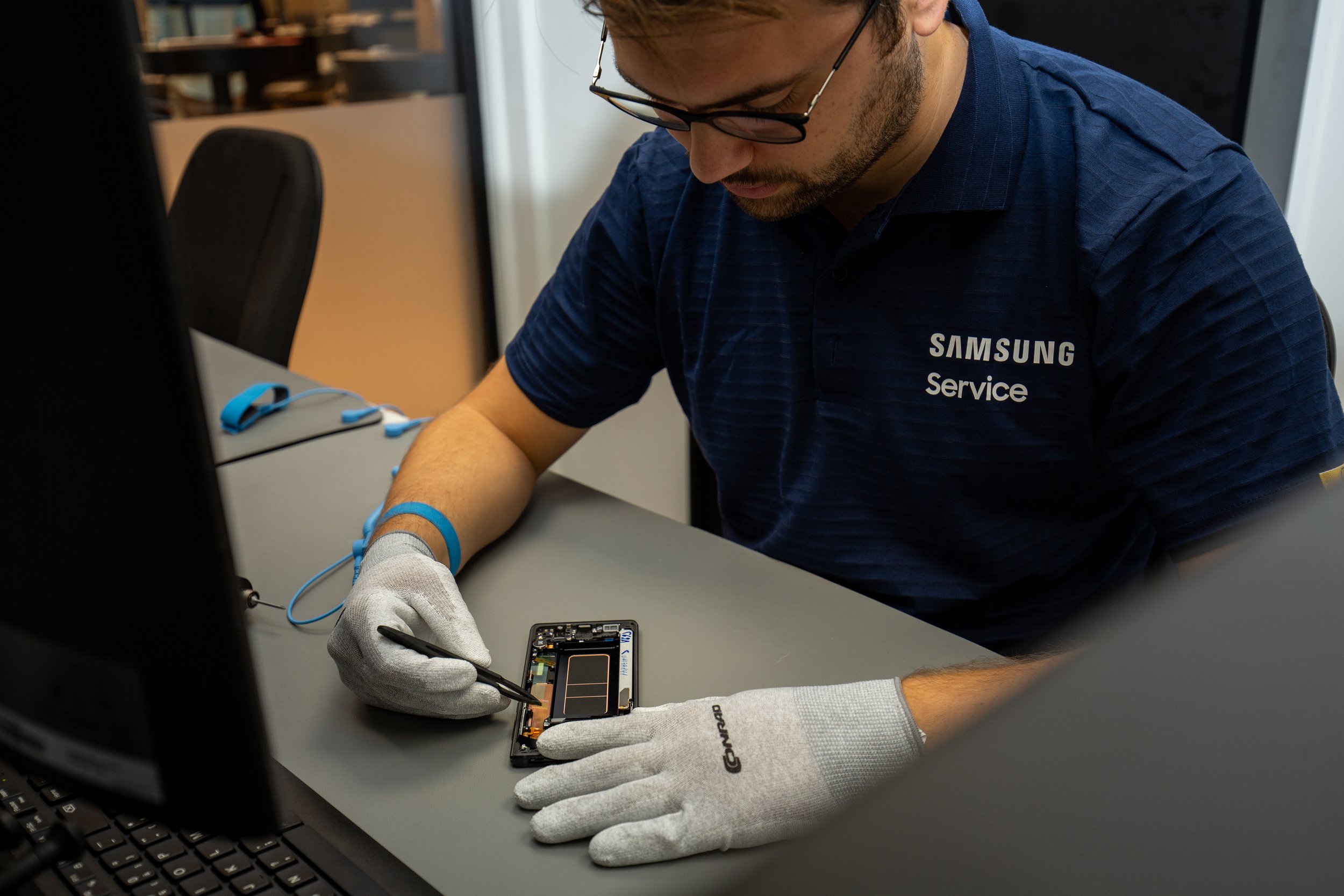 Samsung technician repairing a phone with pincers