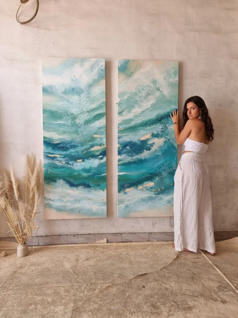 Elisa de la Torre with her paintings