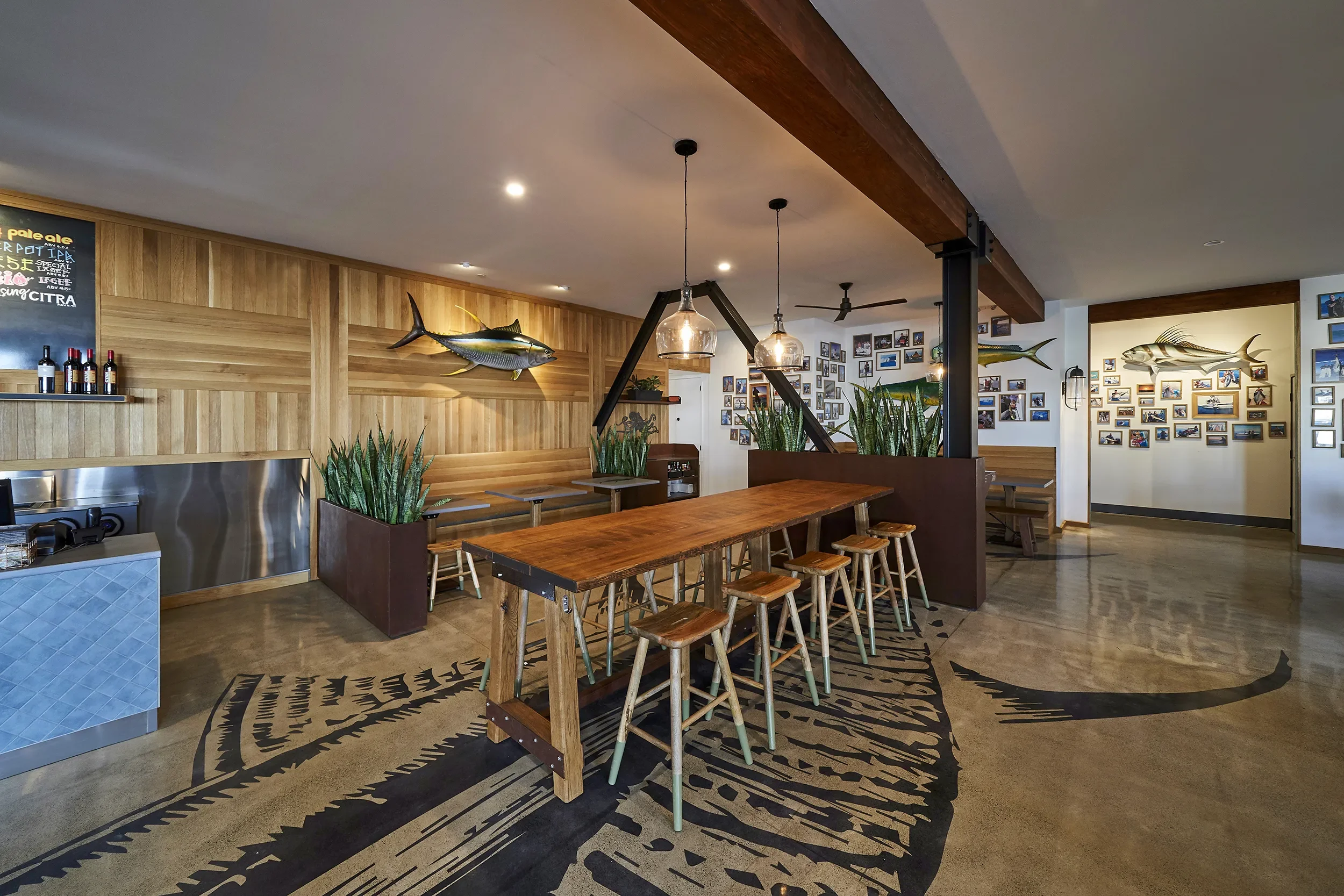 Wood counter seating under an exposed beam ceiling at Blue Water in Ocean Beach, San Diego