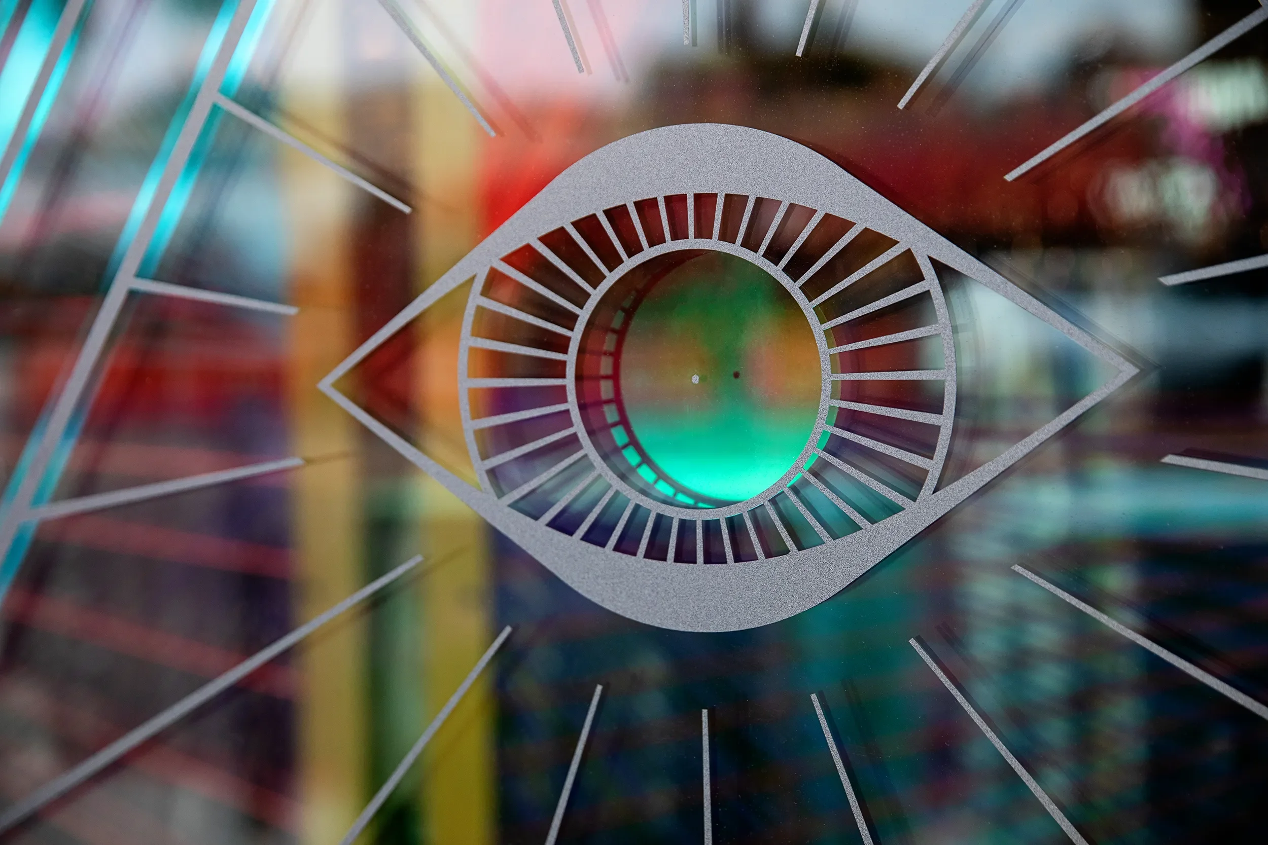 Dichroic film eye emblem graphic applied to the retail window at Gypsy feather in Encinitas