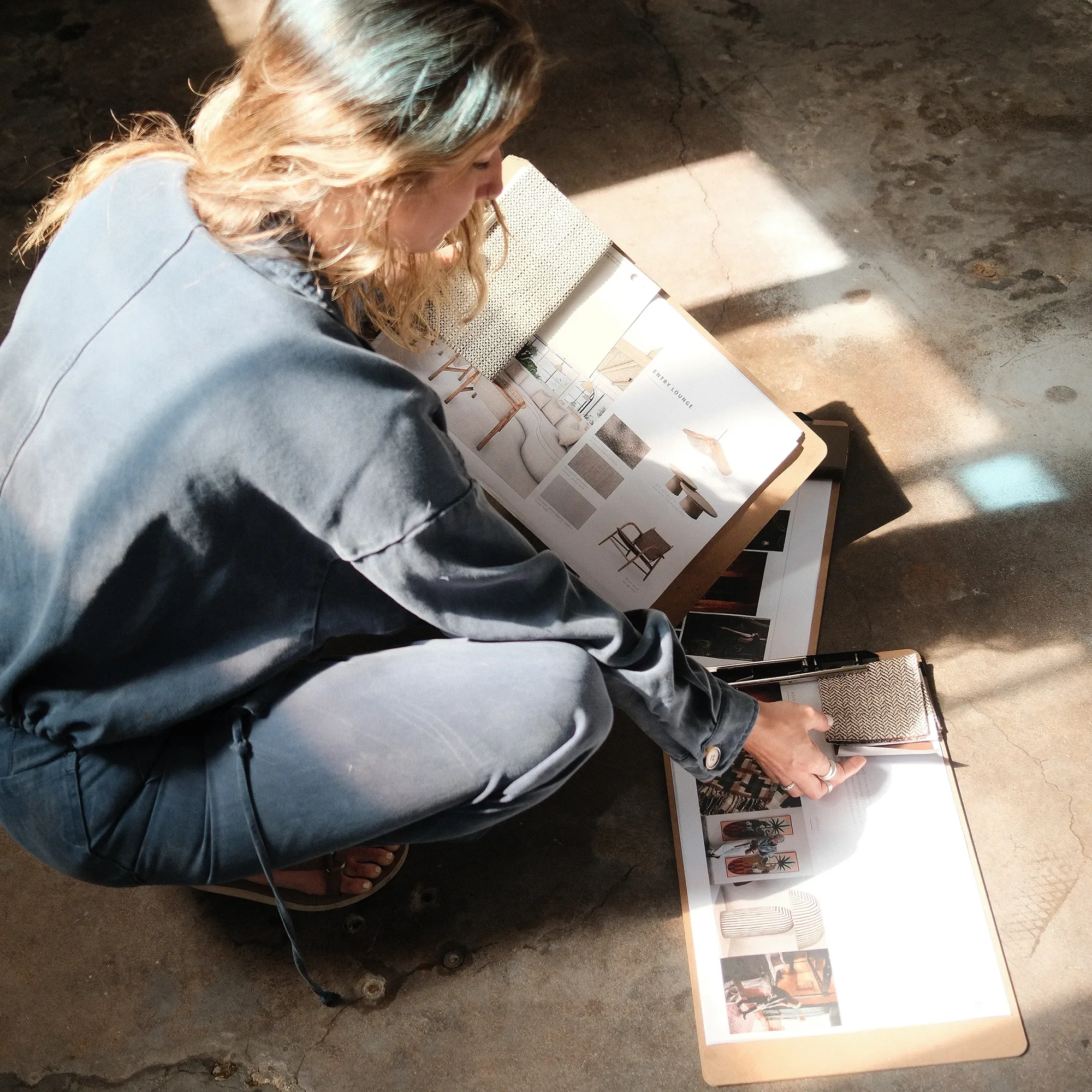 Designer reviewing a materials and finish board during schematic design at Tecture Studio