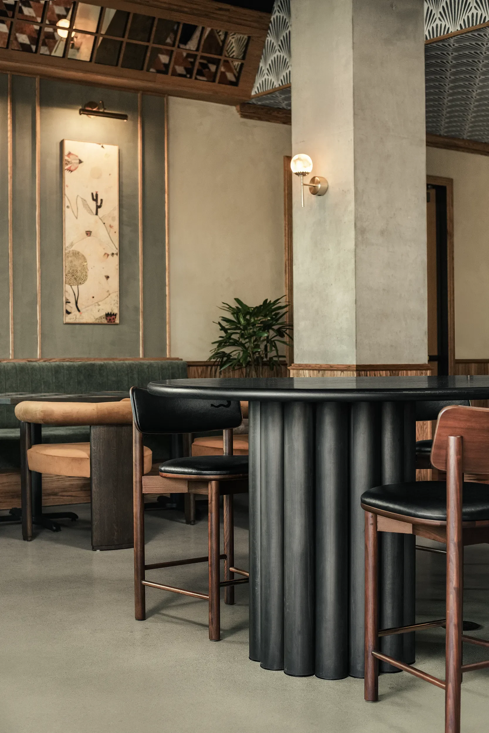 Custom dark wood dining table and olive green velvet banquette at Base Pair Cafe in Torrey Pines, San Diego