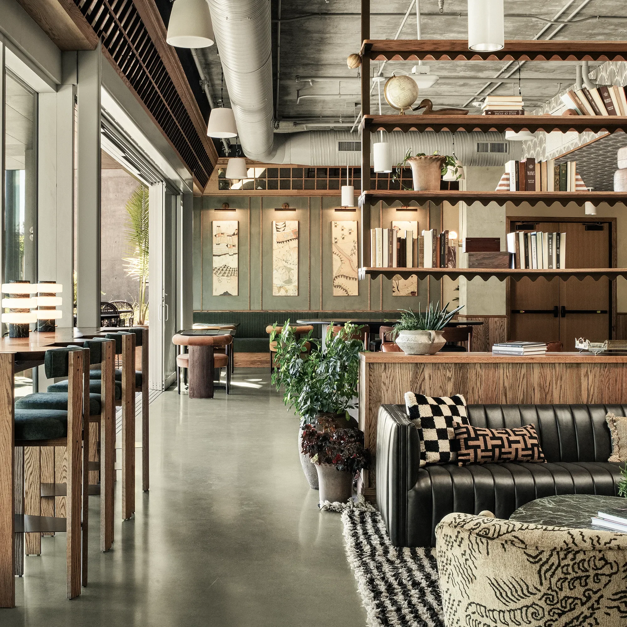 Lounge seating, open shelving, and checkered flooring in the interior at Base Pair Cafe