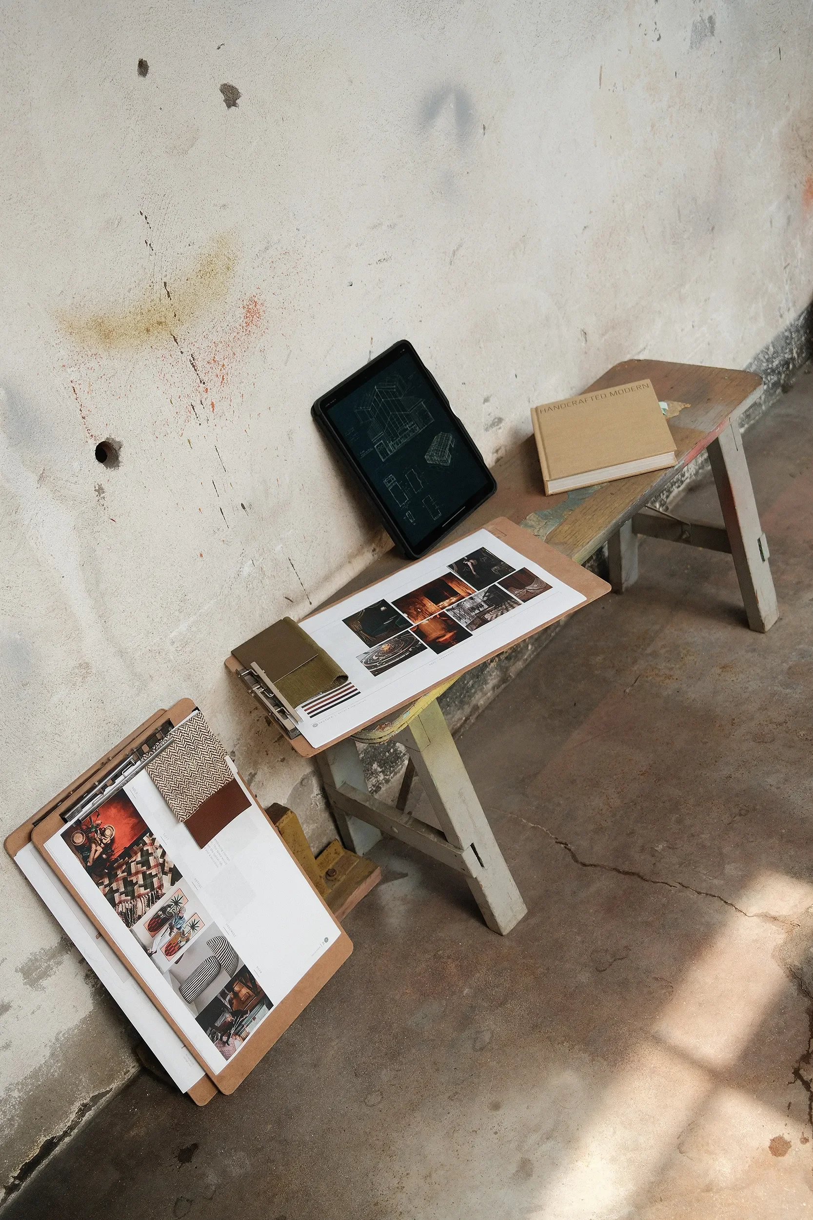 Material samples, finish boards, and floor plans laid out during multi-family design development