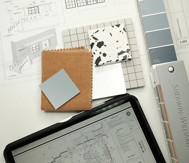 Floor plans on an Ipad with a paint fan deck, leather, terrazzo and stone samples.