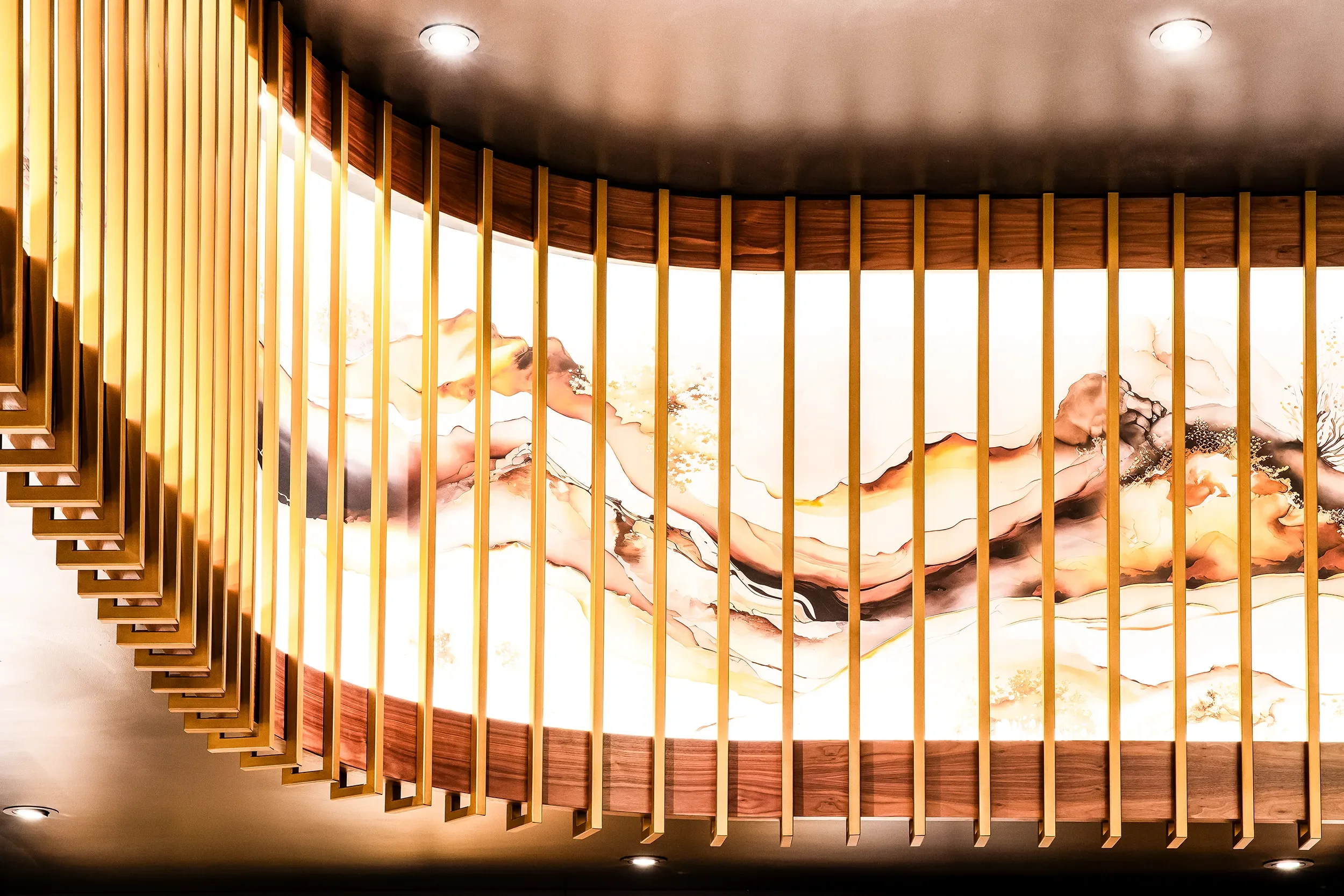 Curved backlit wood fin ceiling running over a lounge at Emerald Casino in Jamul