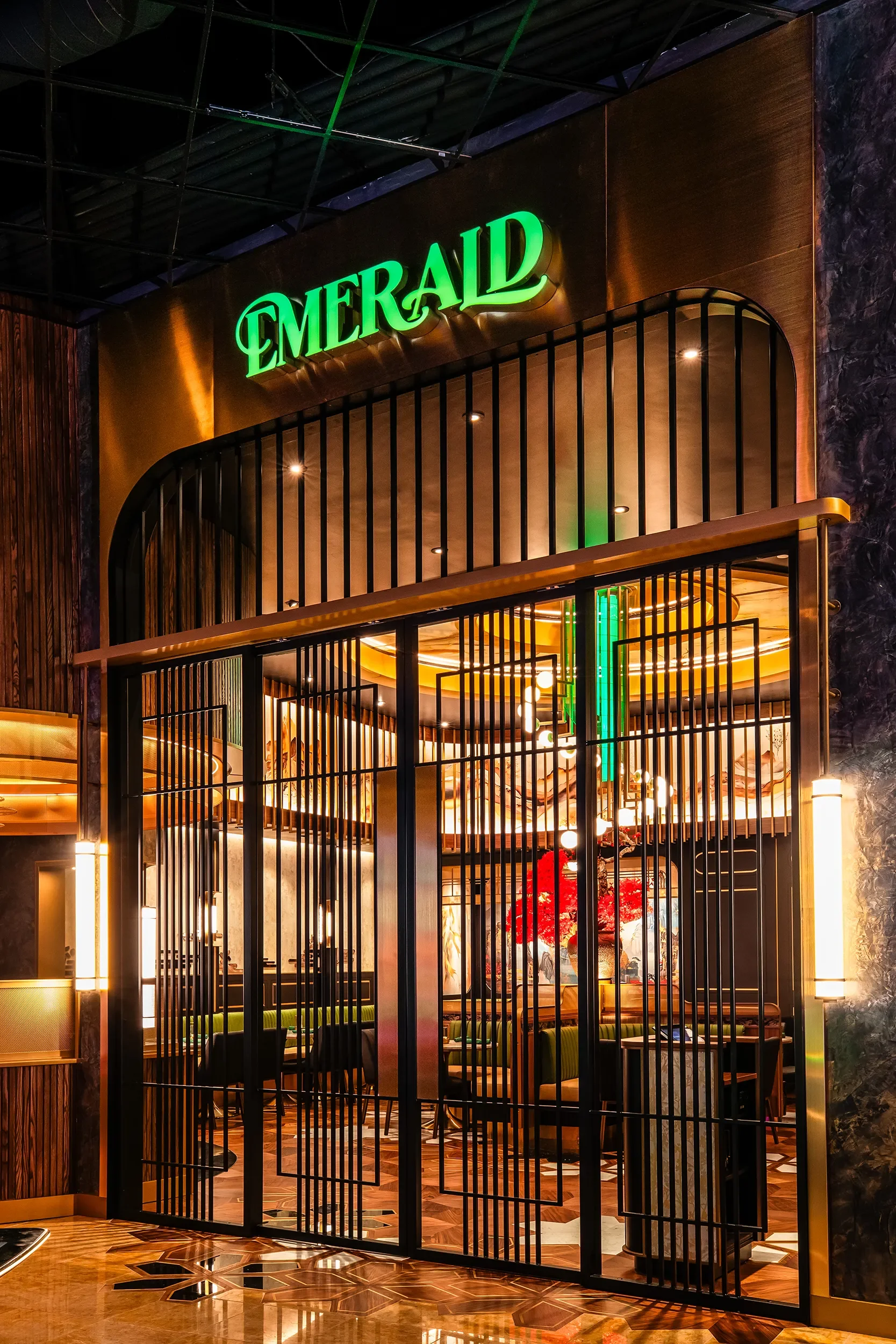 Dark metal entry gate and green lit signage at the Emerald Casino storefront in Jamul