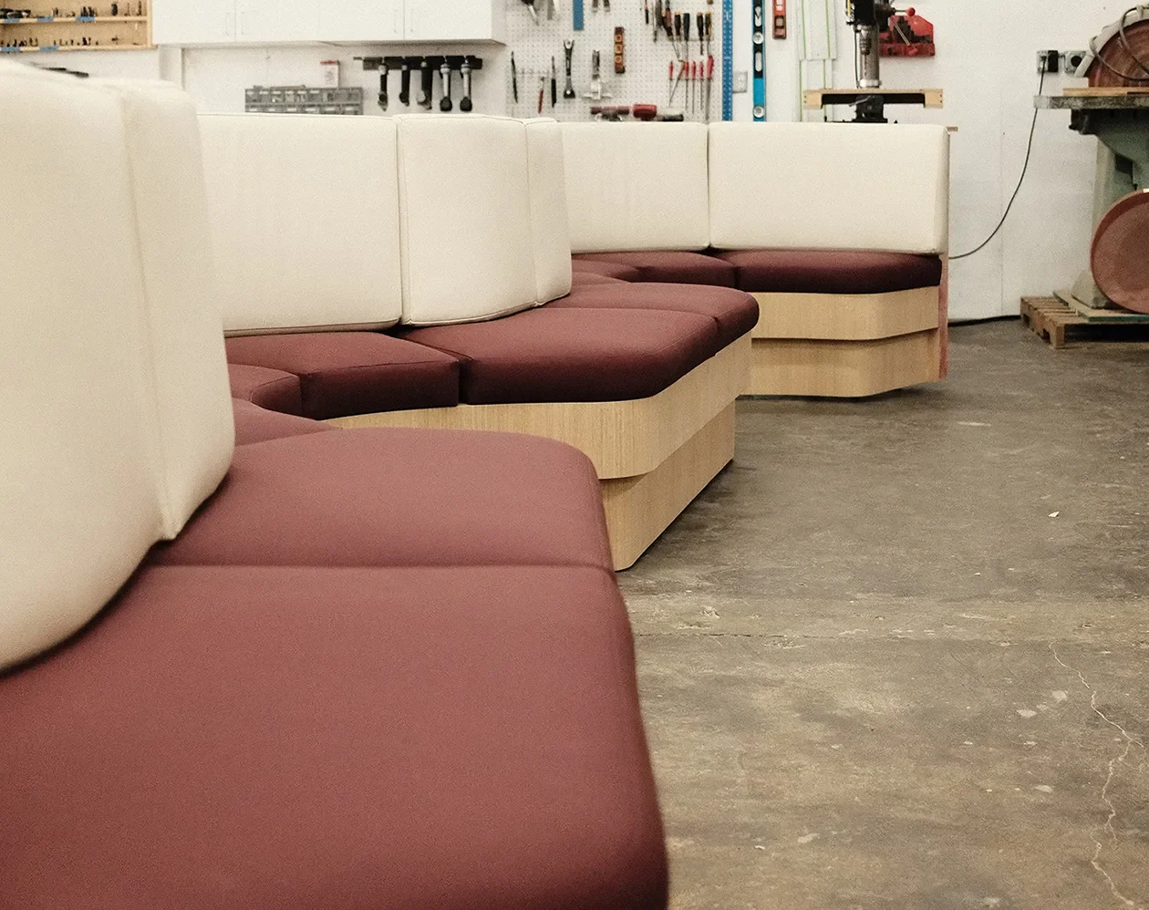 Custom upholstered banquette seating on the Tecture shop floor before prepping for delivery.