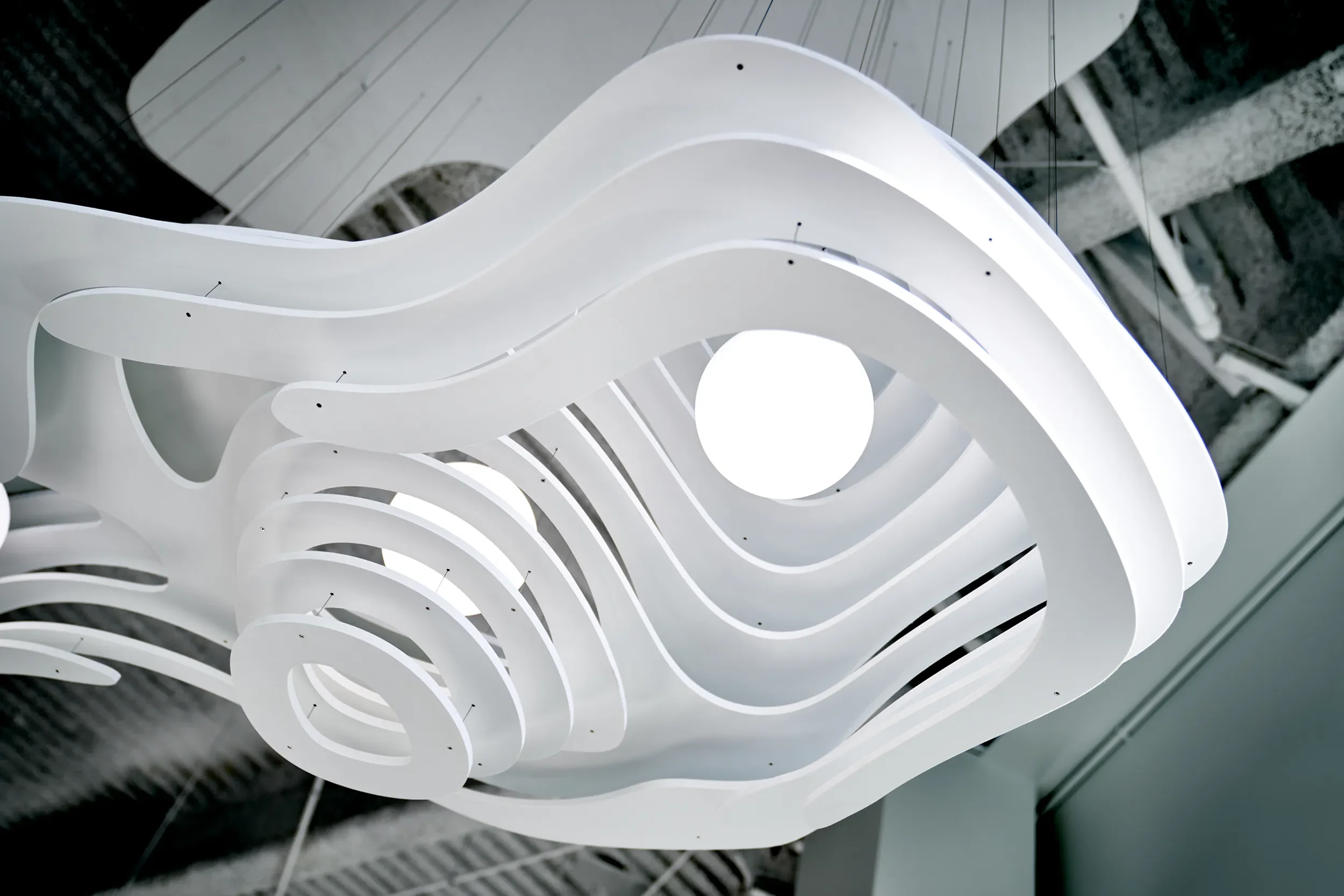White layered pendant light sculpture fabricated for the CBRE office in San Diego