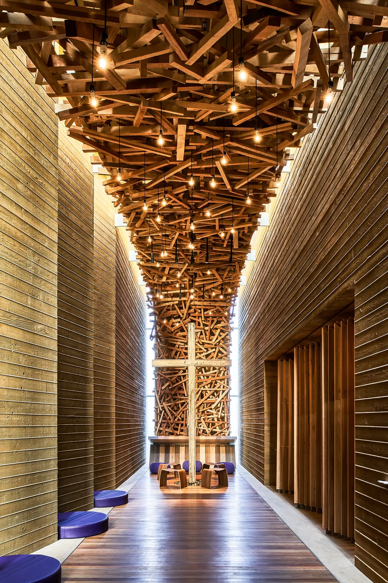 Backlit wood slat ceiling running the length of the chapel corridor at Prescott Chapel