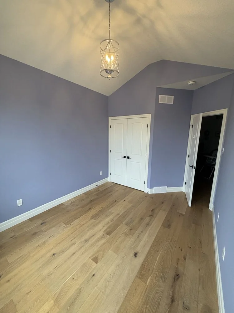 Vaulted spare bedroom painted Blue Pearl with white trim in Dorchester, Ontario