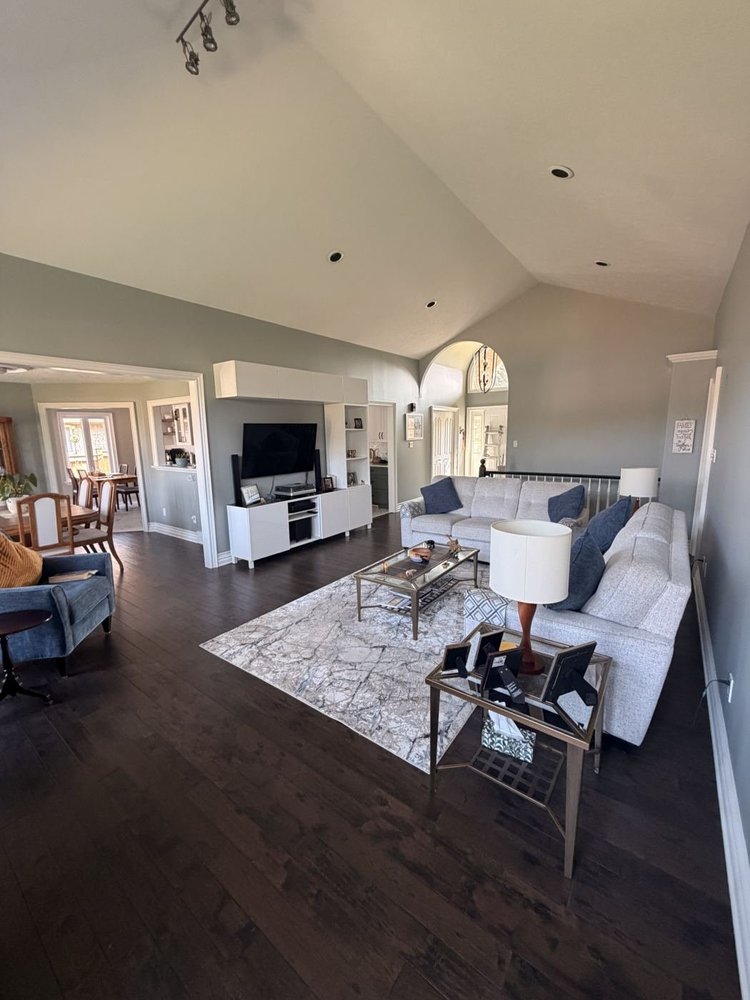 Vaulted living room repainted in a soft grey-green with white trim in Dorchester, Ontario