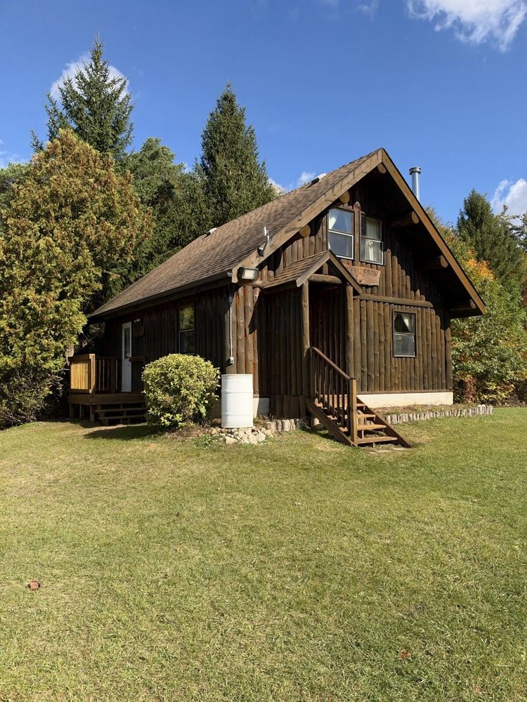 Log cabin restained in Pecan at a camp near Drumbo, Ontario